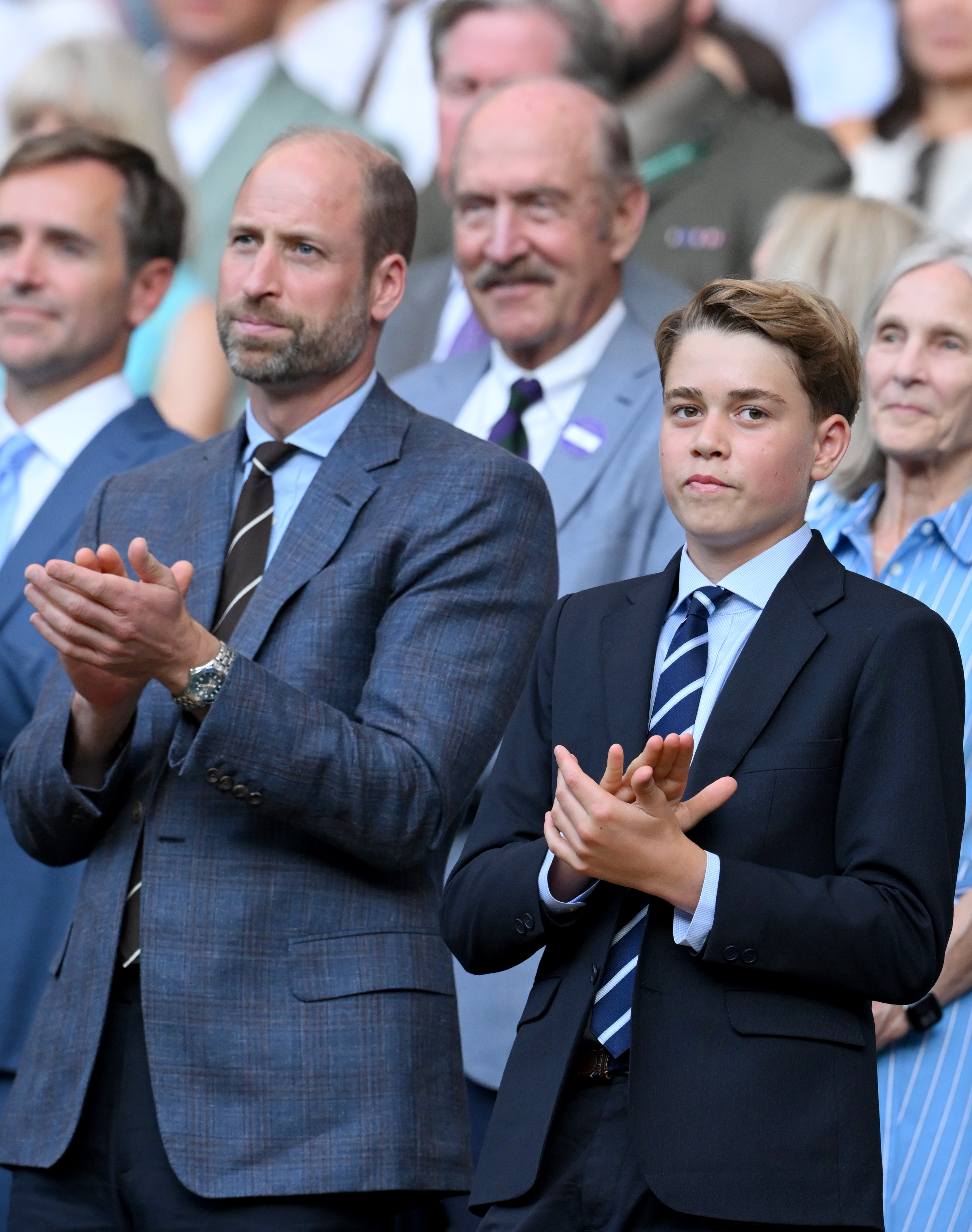 LONDON, ENGLAND - JULY 12: Prince William, Prince of Wales and Prince George of Wales clap as they attend day fourteen of the 2026 Wimbledon Tennis Championships at the All England Lawn Tennis and Croquet Club on July 12, 2026 in London, England.  (Photo by Karwai Tang/WireImage)