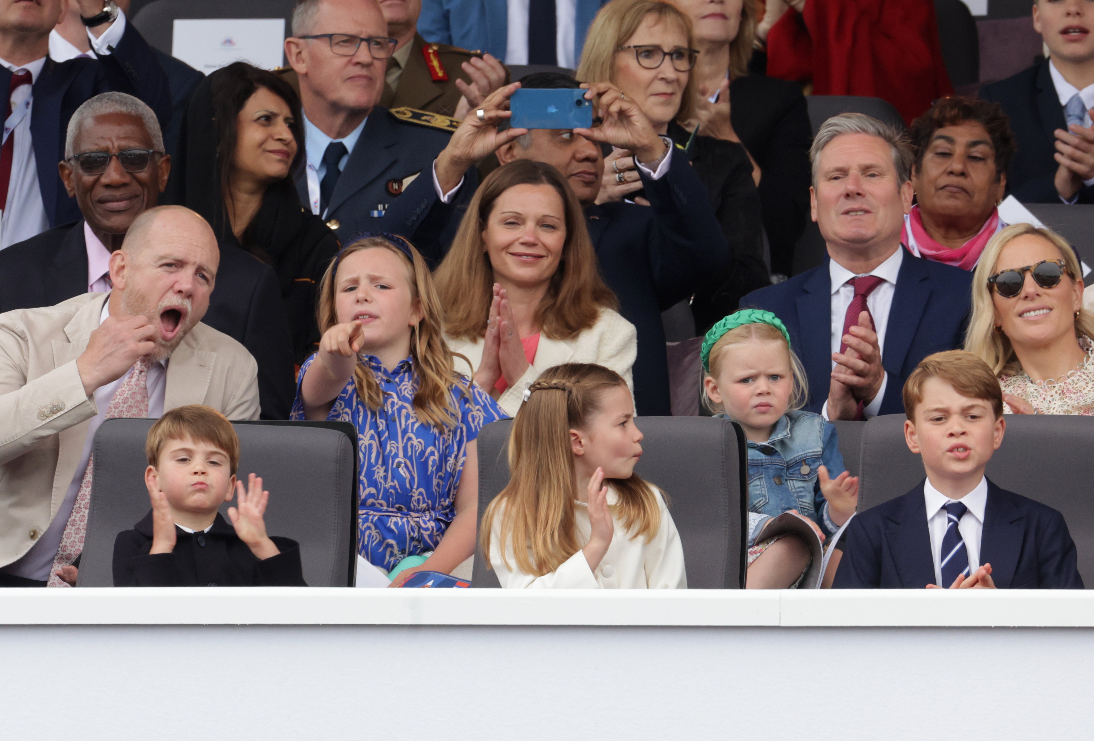 LONDON, ENGLAND - JUNE 05: (L-R 2nd row) Mike Tindall, Mia Tindall, Victoria Starmer, Lena Tindall, Keir Starmer, Zara Tindall (front row) Prince Louis of Cambridge, Princess Charlotte of Cambridge and Prince George of Cambridge watch the Platinum Pageant on June 05, 2022 in London, England. The Platinum Jubilee of Elizabeth II is being celebrated from June 2 to June 5, 2022, in the UK and Commonwealth to mark the 70th anniversary of the accession of Queen Elizabeth II on 6 February 1952.  (Photo by Chris Jackson - WPA Pool/Getty Images)