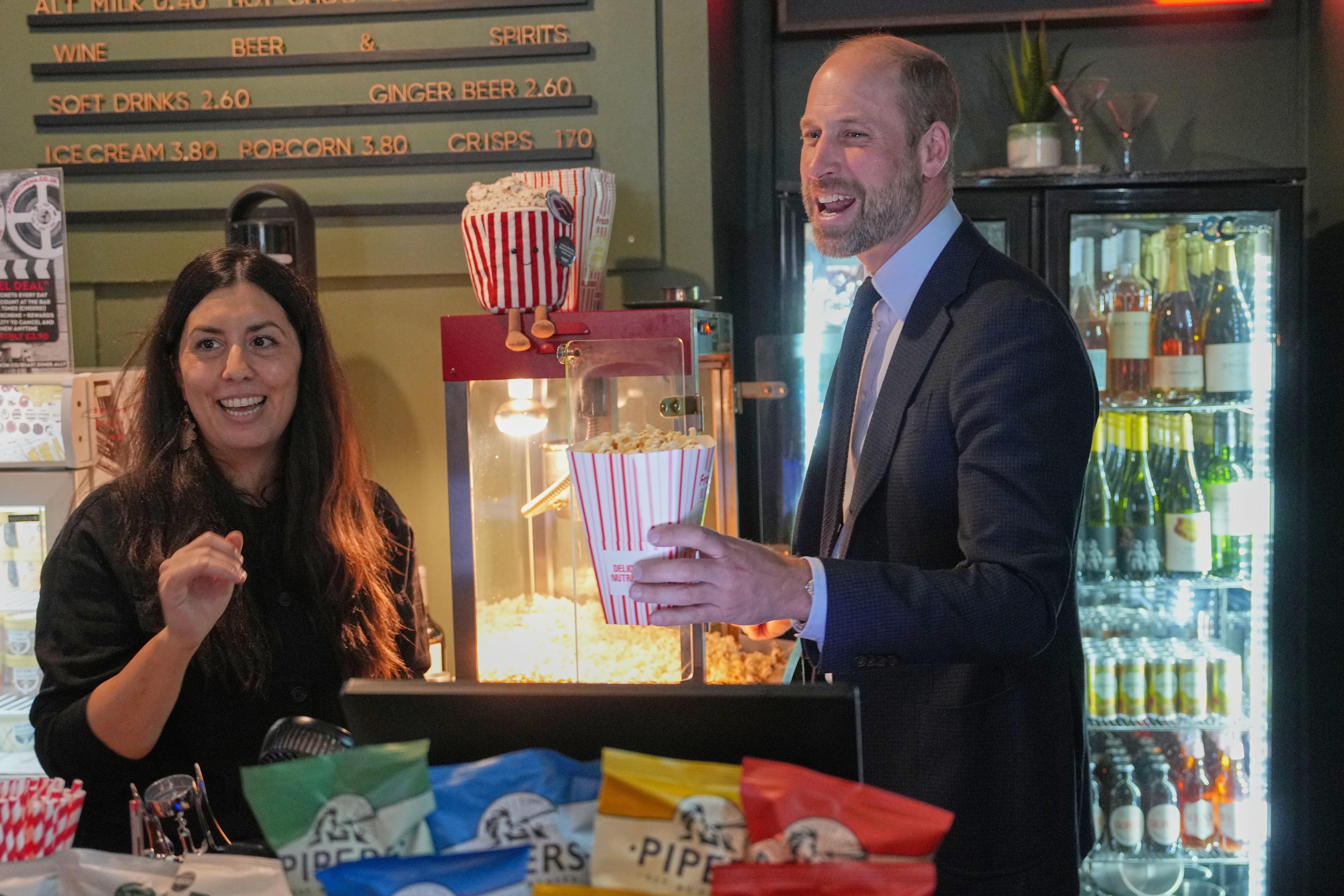 Prince William serves customers popcorn as he visits ActOne, an independent, community-led cinema to celebrate the richness and talent of the British film industry, in London, Tuesday, Sept. 22, 2026. (AP Photo/Kin Cheung, Pool)