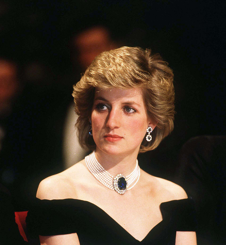 VIENNA, AUSTRIA - APRIL 16: Diana, Princess of Wales, wearing a midnight blue velvet, off the shoulder evening dress designed by Victor Edelstein, a sapphire, diamond and pearl choker and diamond and sapphire earrings, attends a state banquet on April 16, 1986 in Vienna, Austria. (Photo by Anwar Hussein/WireImage)