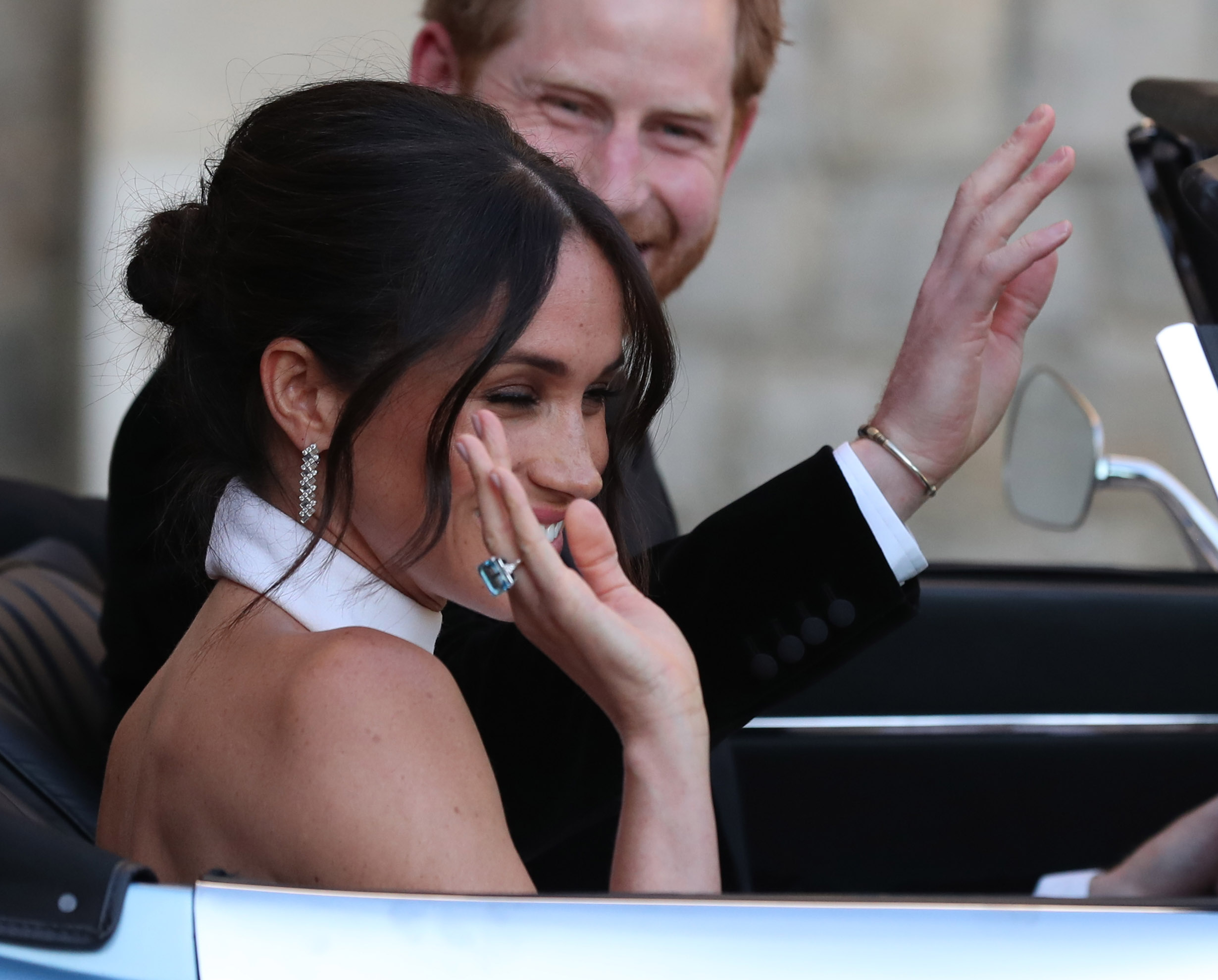 The newly married Duke and Duchess of Sussex, Meghan Markle and Prince Harry, leaving Windsor Castle after their wedding to attend an evening reception at Frogmore House, hosted by the Prince of Wales. The bride wore a ring which belonged to Diana, Princess of Wales. PRESS ASSOCIATION Photo. Picture date: Saturday May 19, 2018. Meghan wore See PA story ROYAL Wedding. Photo credit should read: Steve Parsons/PA Wire