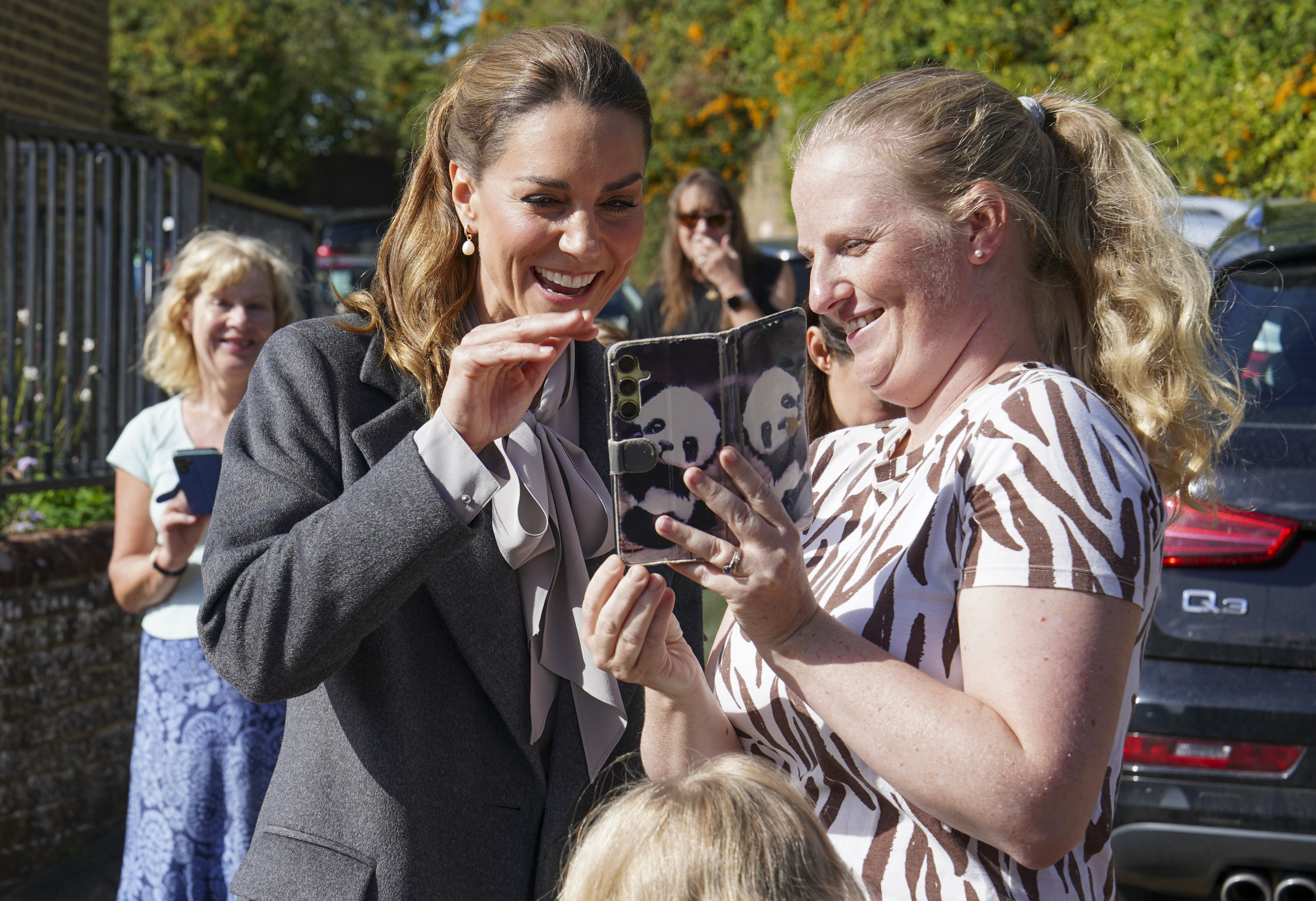 PULBOROUGH, ENGLAND - SEPTEMBER 30: Catherine, Princess of Wales waves to Amanda Ridley's mother and sister on FaceTime as she visits West Sussex Minibus, a volunteer-led community transport group, which acts as a vital lifeline for people who cannot easily access public transport due to isolation, mobility challenges or financial barriers, on September 30, 2026 in Pulborough, England. The Princess's visit highlighted the role community transport plays in bringing people together. (Photo by Arthur Edwards - WPA Pool/Getty Images)