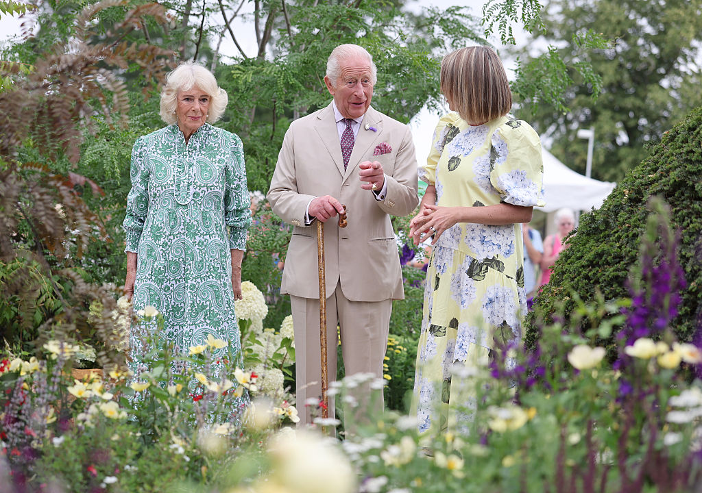 SANDRINGHAM, NORFOLK - JULY 22: Queen Camilla (L) and King Charles III speak with garden designer Catherine MacDonald as they visit the Royal Legacy Garden at the first RHS Sandringham Flower Show at Royal Sandringham Estate on July 22, 2026 in Sandringham, Norfolk. The event was the first Royal Horticultural Society (RHS) show to be held at Sandringham Estate.  (Photo by Chris Jackson/Getty Images)
