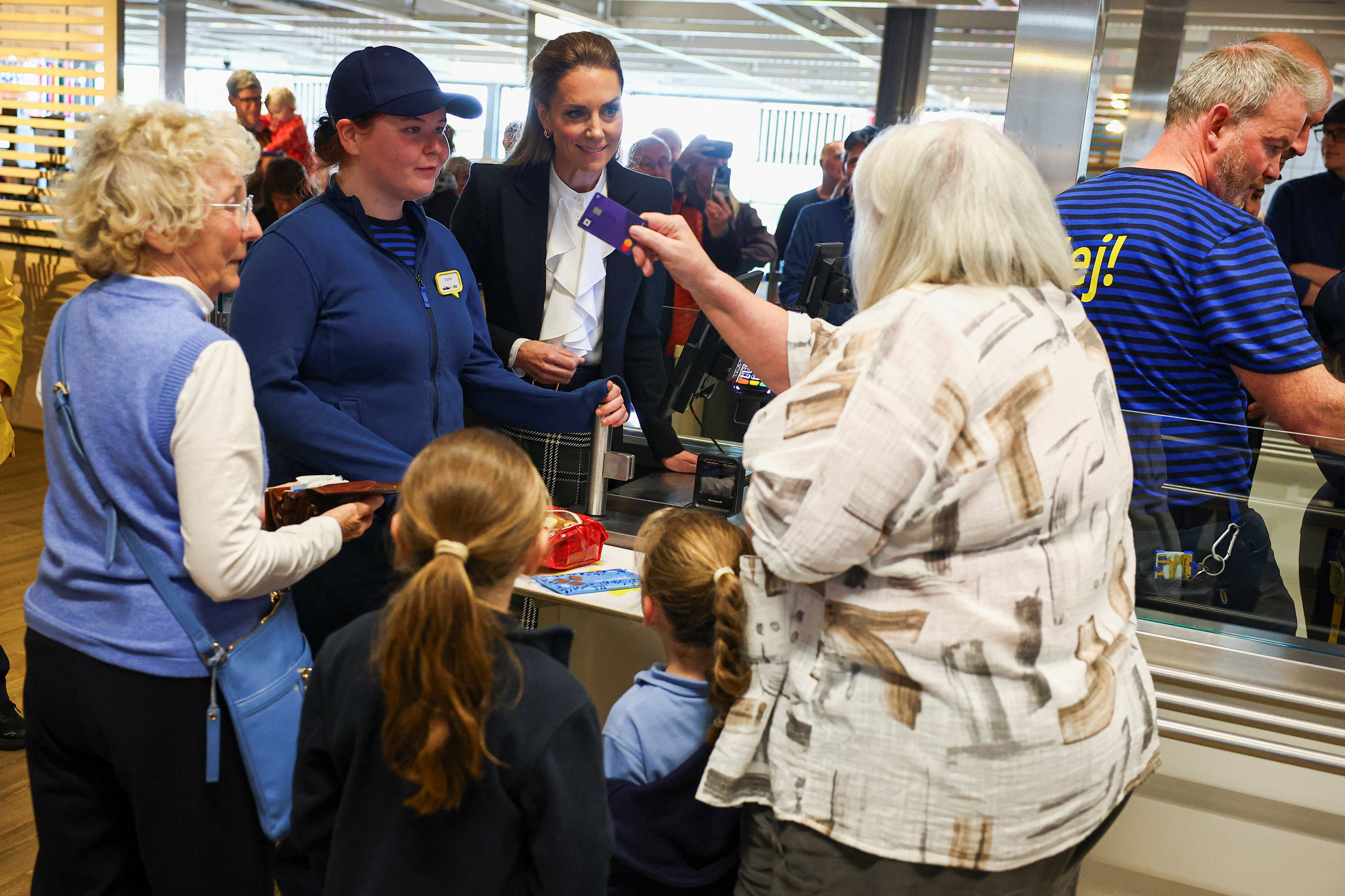 Catherine, Princess of Wales, helps behind the till during a visit to an IKEA store to learn about the company's work supporting care-experienced young people on their journey into employment, during their visit to Northern Ireland on October 09, 2026 in Belfast, Northern Ireland. (Photo by Phil Noble - WPA Pool/Getty Images)