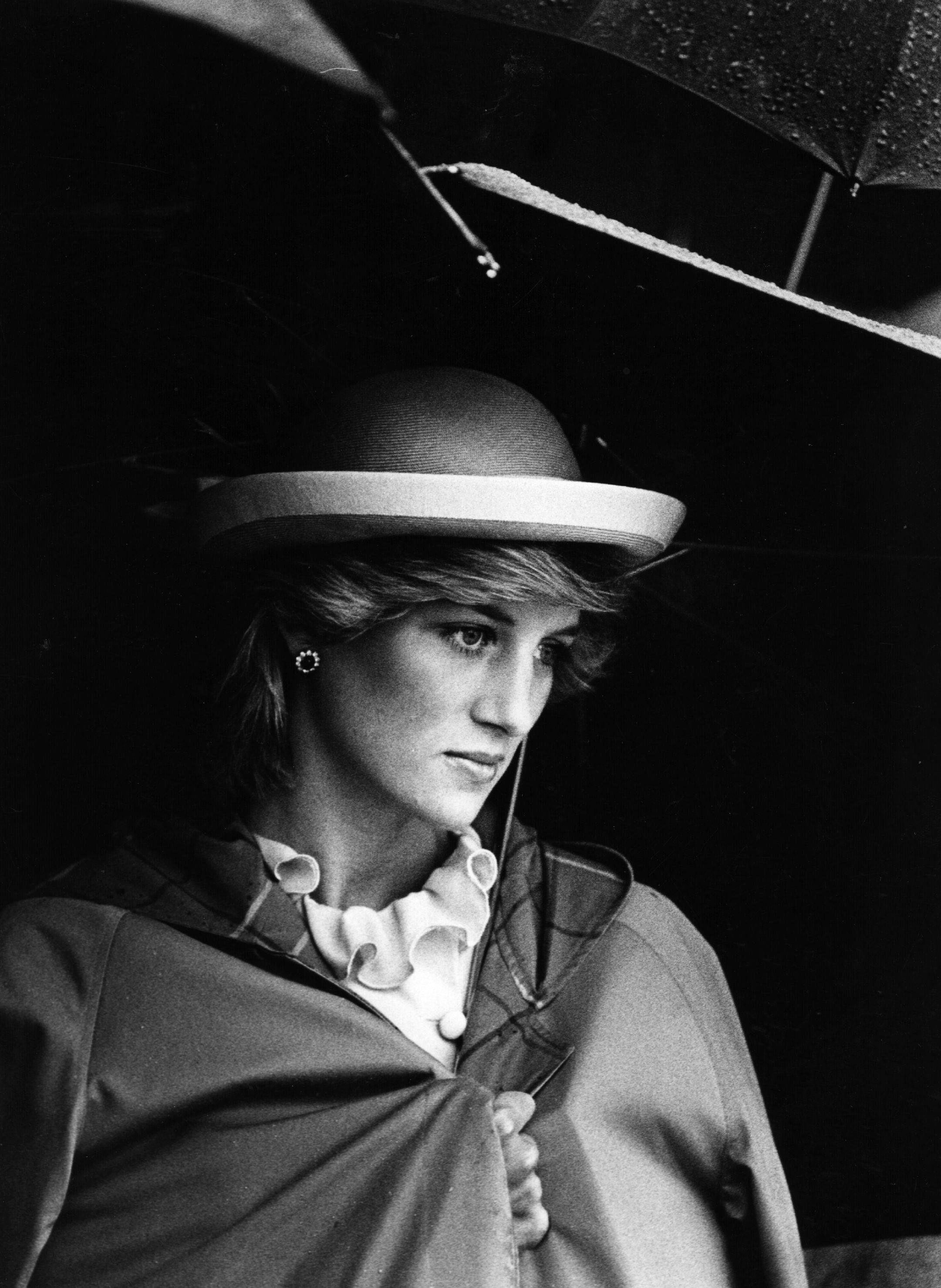 Lady Diana Spencer (1961 - 1997), future Princess of Wales sheltering under an umbrella.   (Photo by Hulton Archive/Getty Images)