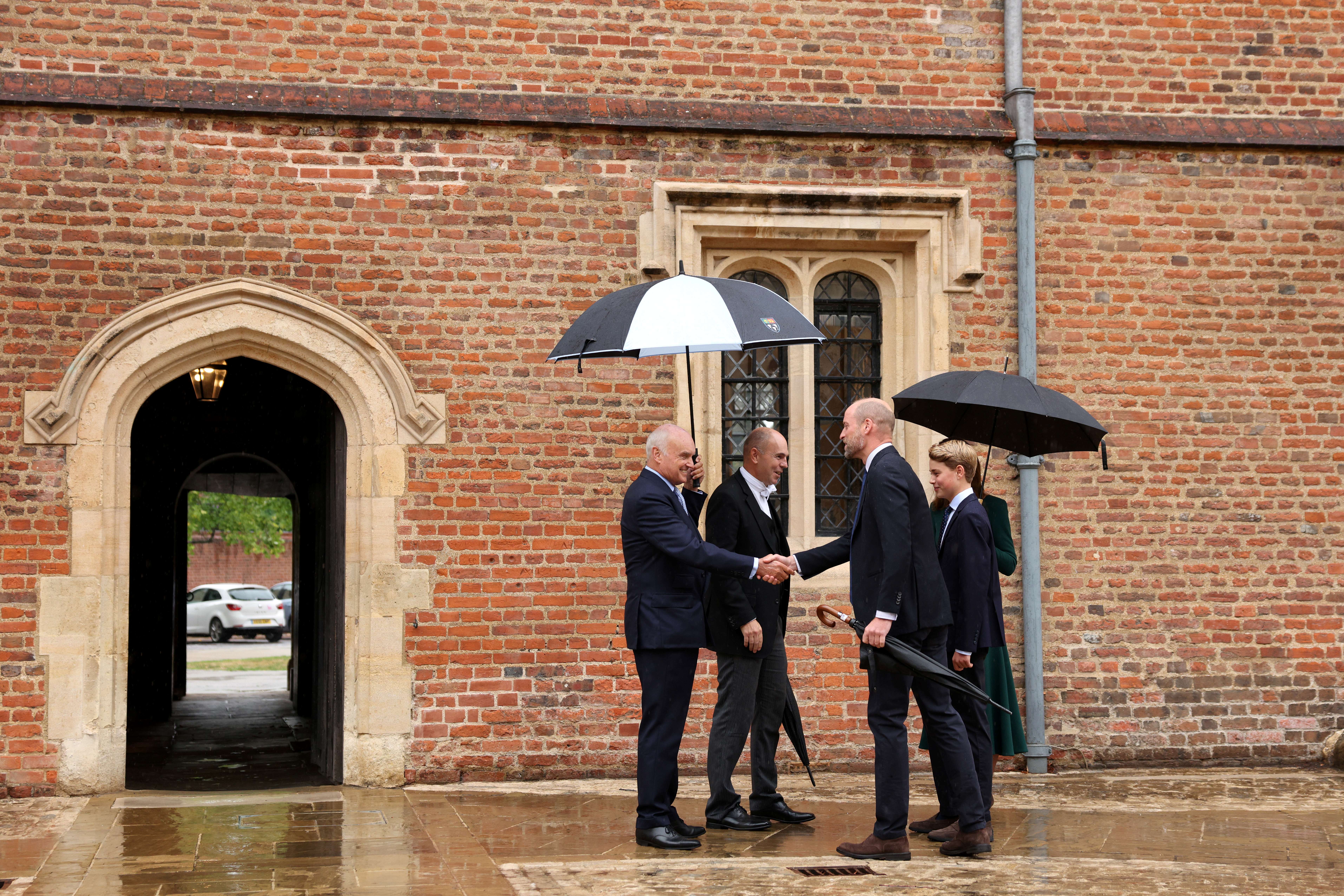 ETON, ENGLAND - SEPTEMBER 8:  Prince William, Prince of Wales (front R), Catherine, Princess of Wales (behind R) and their 13-year-old son, Prince George of Wales (R), are met by headmaster Simon Henderson (2nd L) and provost Nicholas Coleridge (L) as Prince George arrives for his first day at Eton College on September 8, 2026 in Berkshire, England. (Photo by Adrian Dennis - WPA Pool/Getty Images)
