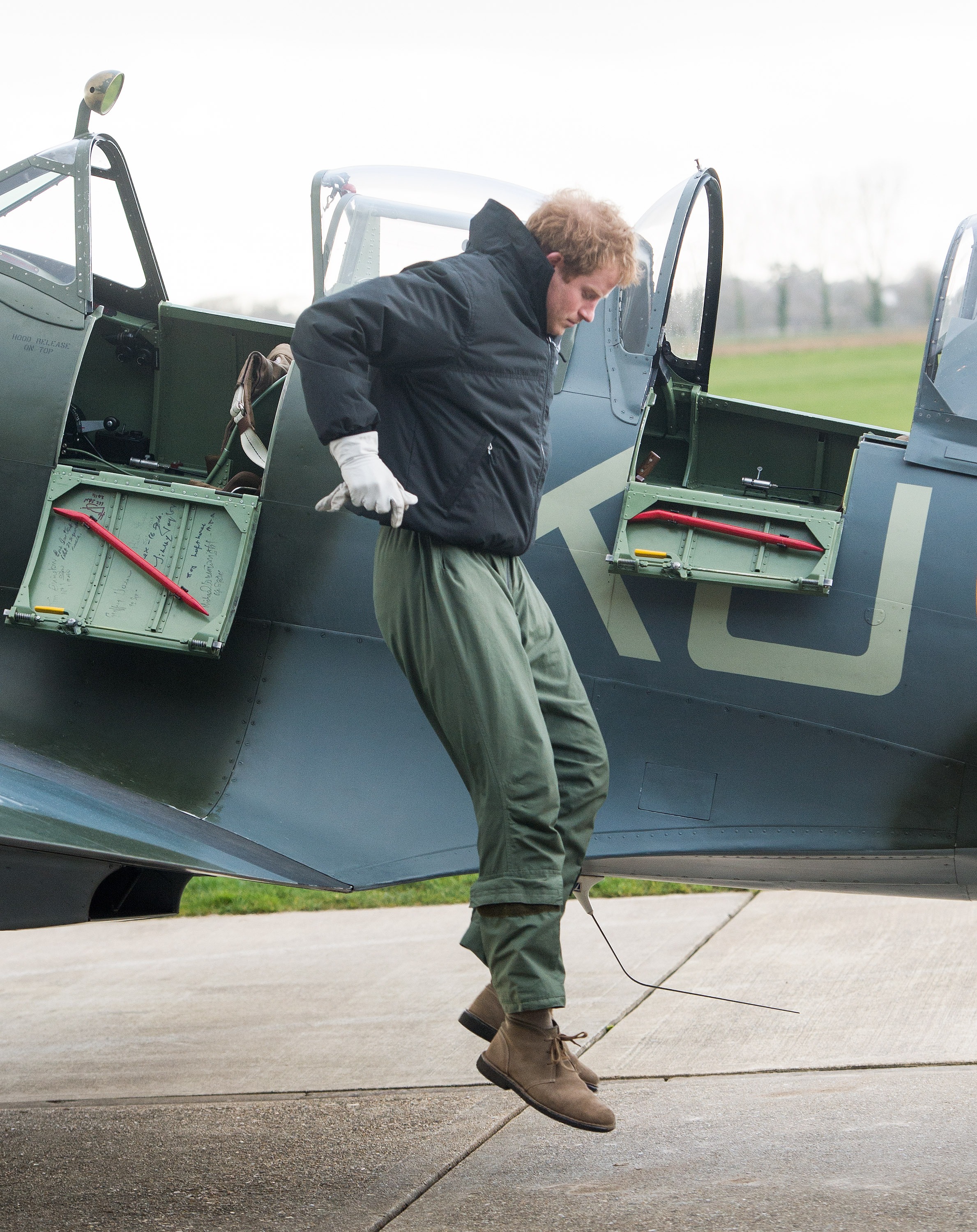 GOODWOOD, ENGLAND - FEBRUARY 15:  Prince Harry jumps from a Spitfire plane as he visits Boultbee Flight Academy on February 15, 2014 in Goodwood, England. (Photo by Samir Hussein/WireImage)