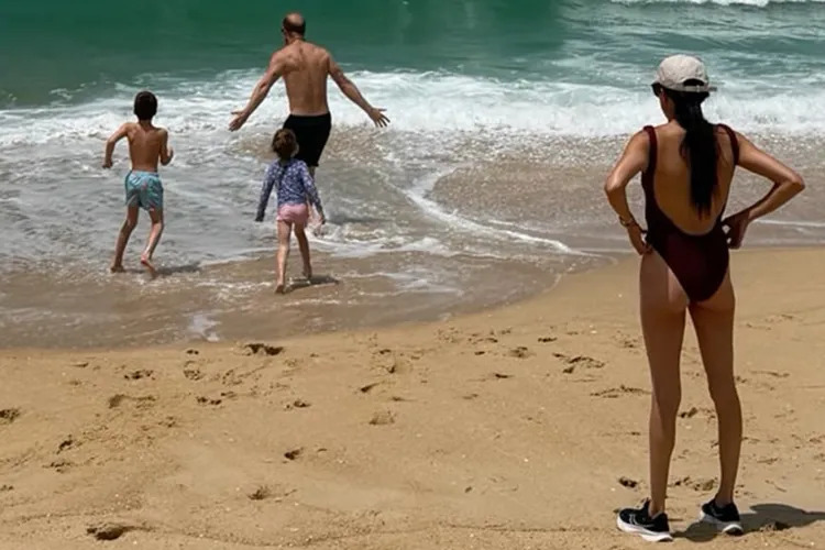 Meghan Markle watches as Prince Harry, Prince Archie, and Princess Lilibet play on the beach. (Image source: Instagram | @meghan.)