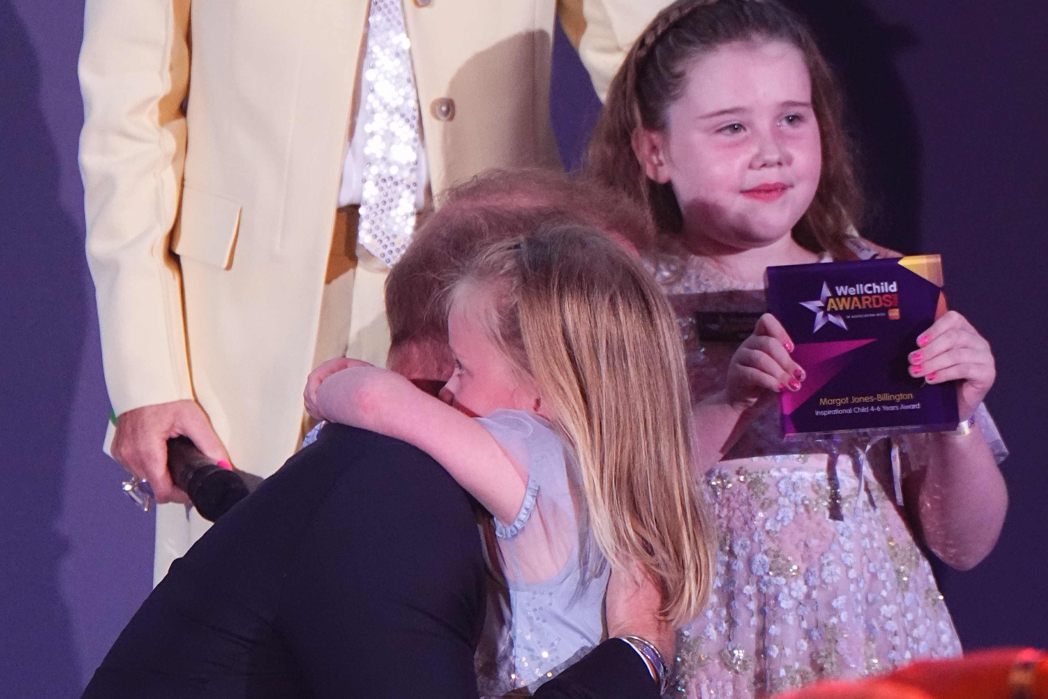 LONDON, ENGLAND - SEPTEMBER 21: Prince Harry, Duke of Sussex receives a hug from Adeleigh, the sister of Inspirational Child 4-6 award to winner, Margot Jones-Billington (R), during the 2026 Wellchild Awards at the Royal Lancaster Hotel on September 21, 2026 in London, England. (Photo by Aaron Chown - Pool/Getty Images)