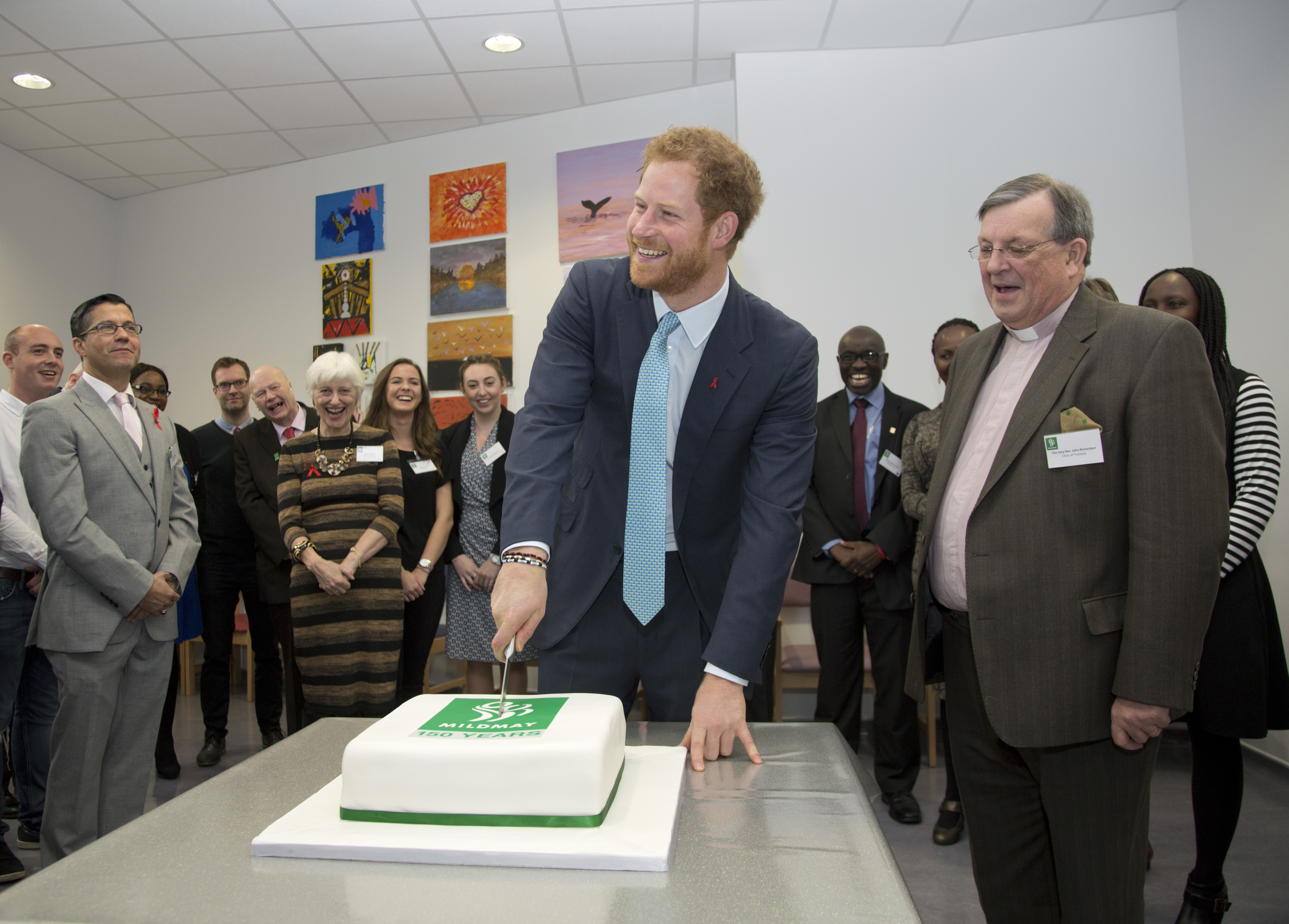 Prince Harry cuts a cake to celebrate the hospital's 150th year next year, during his visit to Mildmay HIV hospital and charity in London, to mark the official opening of their new purpose-built facilities. PRESS ASSOCIATION Photo. Picture date: Monday December 14, 2015. Photo credit should read: Yui Mok/PA Wire