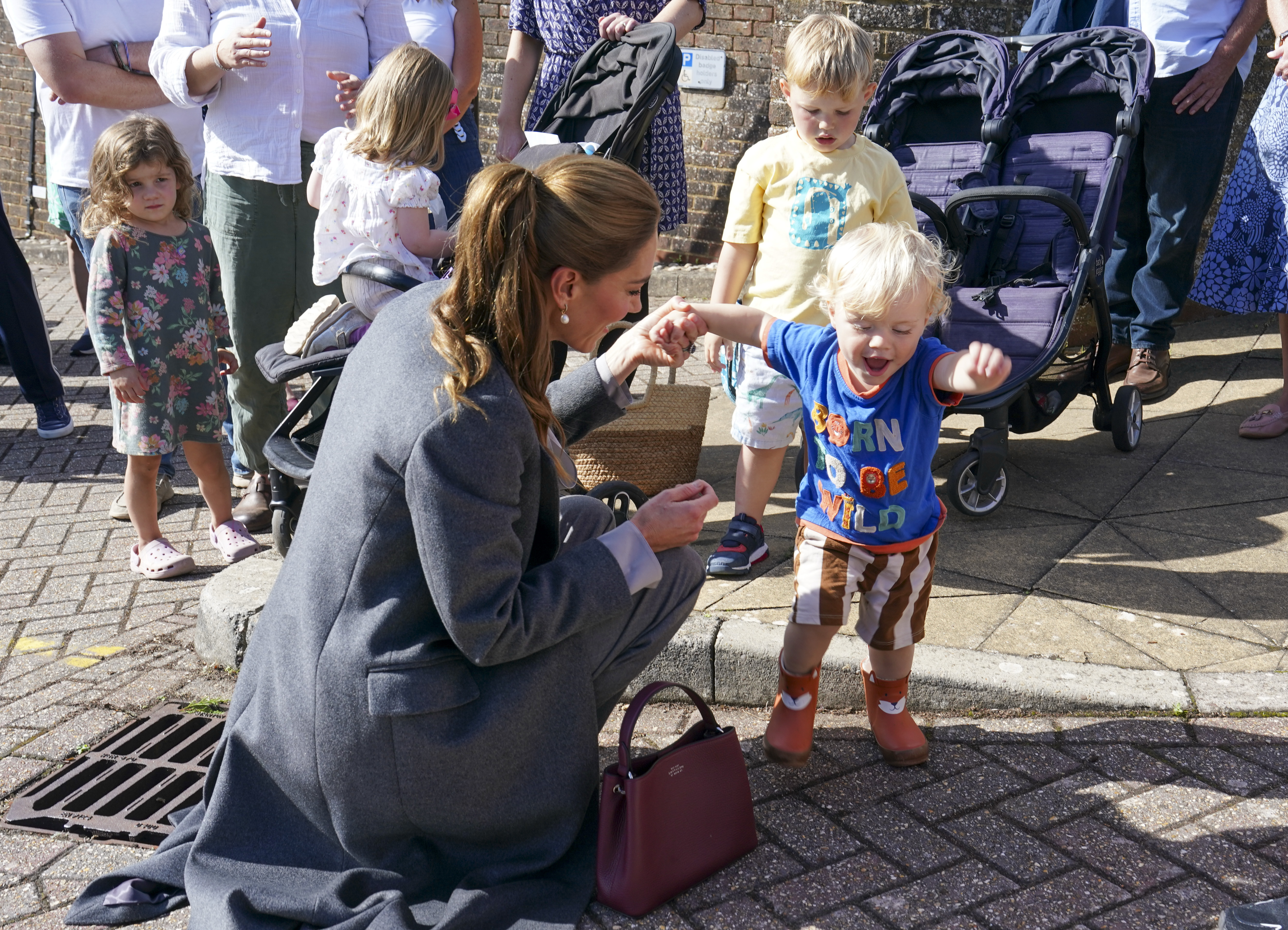PULBOROUGH, ENGLAND - SEPTEMBER 30: Catherine, Princess of Wales plays with Albie Botley-Greenslade age 1 as she visits West Sussex Minibus, a volunteer-led community transport group, which acts as a vital lifeline for people who cannot easily access public transport due to isolation, mobility challenges or barriers, on September 30, 2026 in Pulborough, England. The Princess's visit highlighted the role community transport plays in bringing people together. (Photo by Arthur Edwards - WPA Pool/Getty Images)