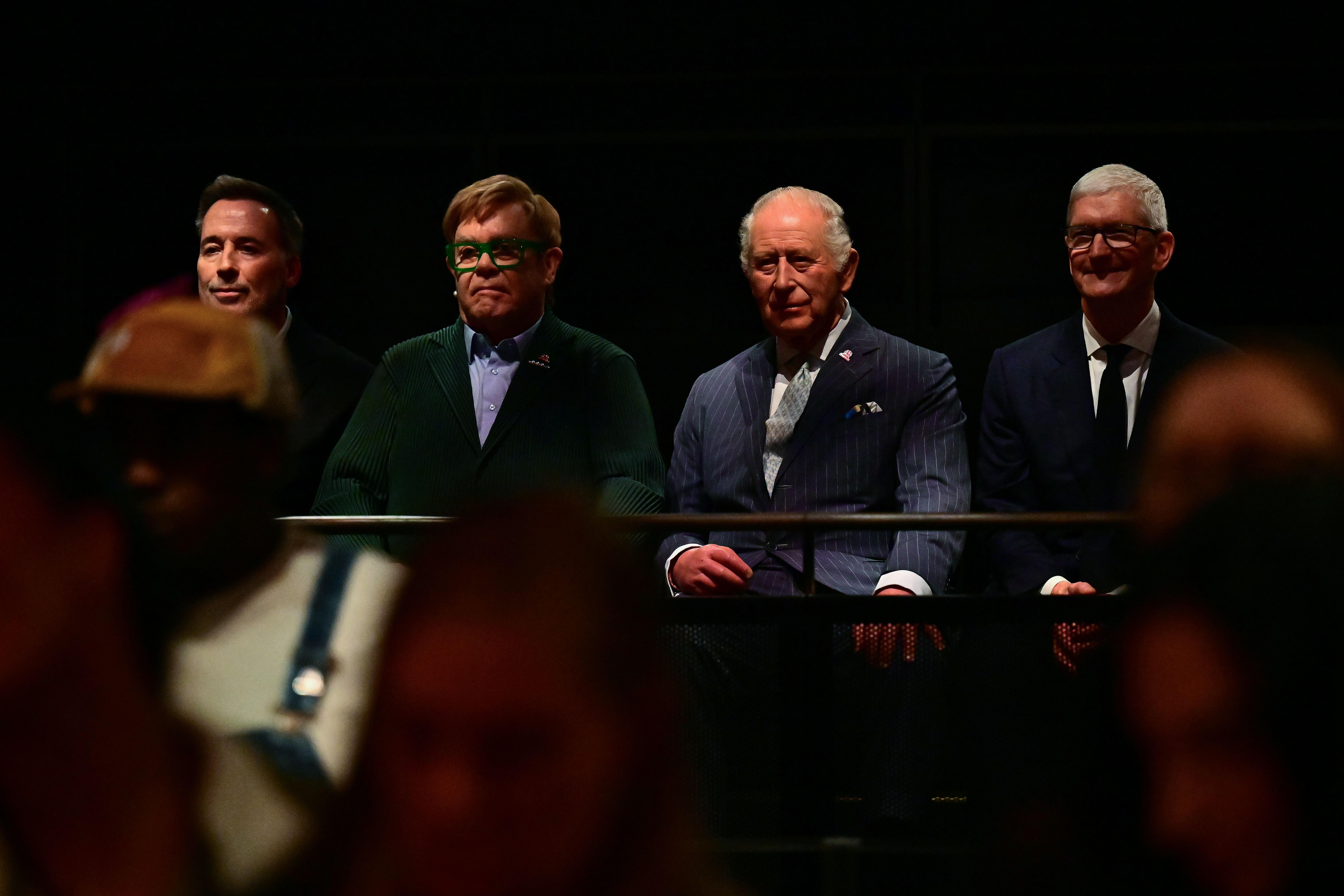LONDON, ENGLAND - OCTOBER 7: King Charles III listens along side British singer-songwriter Elton John (2L), his husband David Furnish (L) and Apple's executive chairman Tim Cook (R) during a soundcheck during a music workshop for young people, the first as part of the Apple x King's Trust Creative Labs, at Battersea Power station on October 7, 2026 in London, England. (Photo by Ben Stansall - WPA Pool/Getty Images)