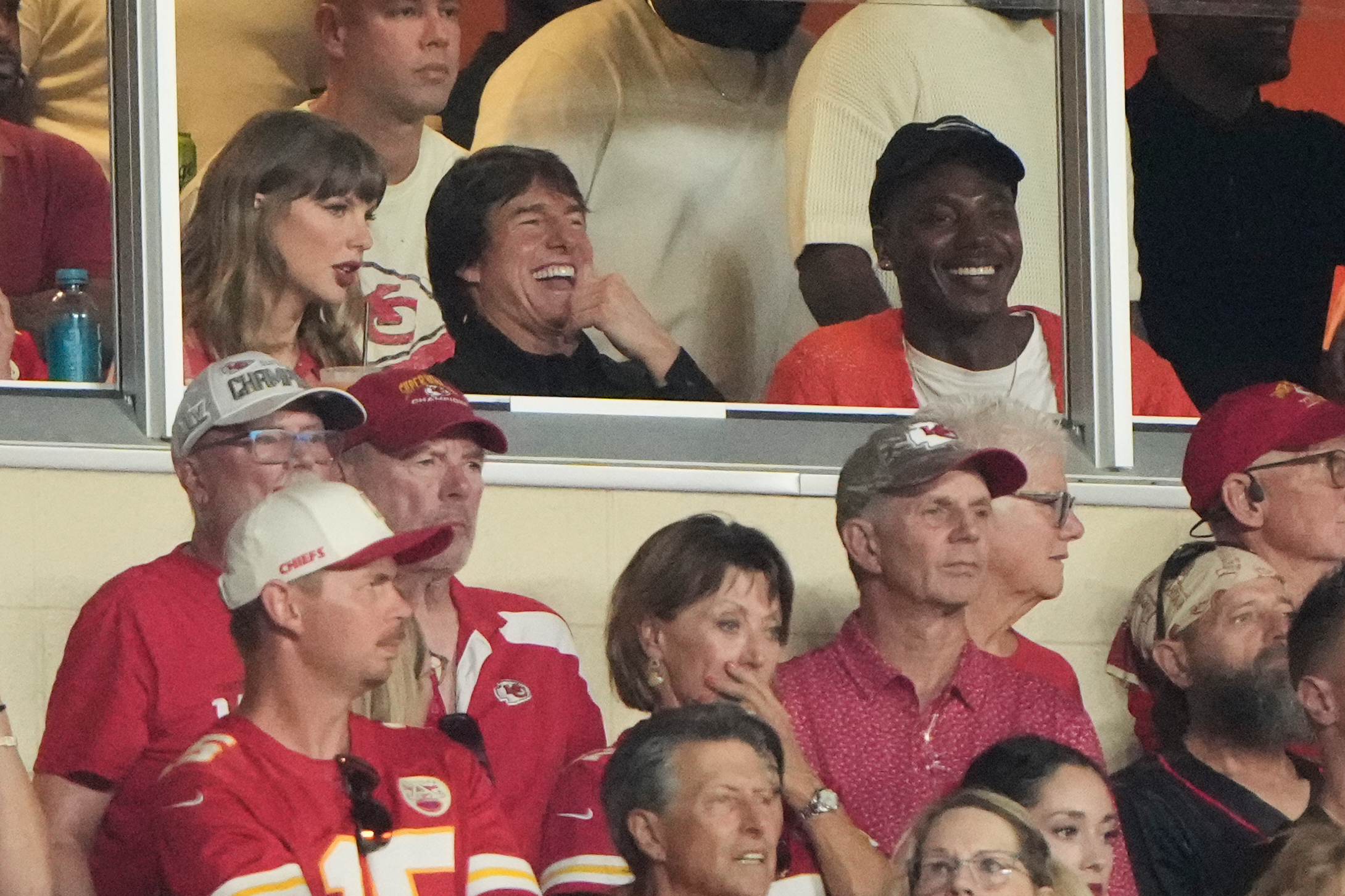 Taylor Swift, left, sits with Tom Cruise, center, while watching the first half of an NFL football game between the Kansas City Chiefs and the Denver Broncos, Monday, Sept. 14, 2026, in Kansas City, Mo. (AP Photo/Charlie Riedel)