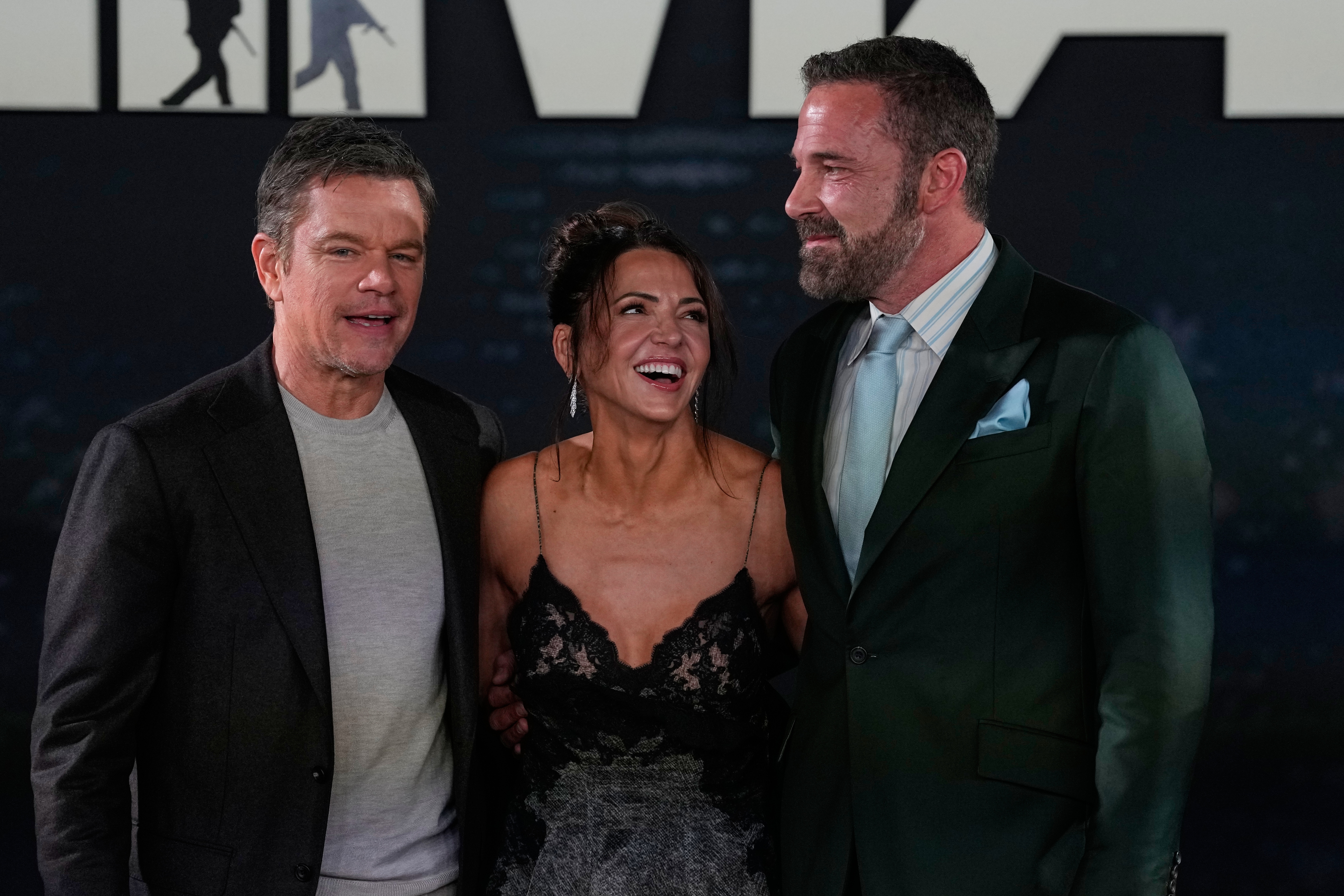 Matt Damon, left, Luciana Barroso, and Ben Affleck pose during a red carpet fan event promoting the film