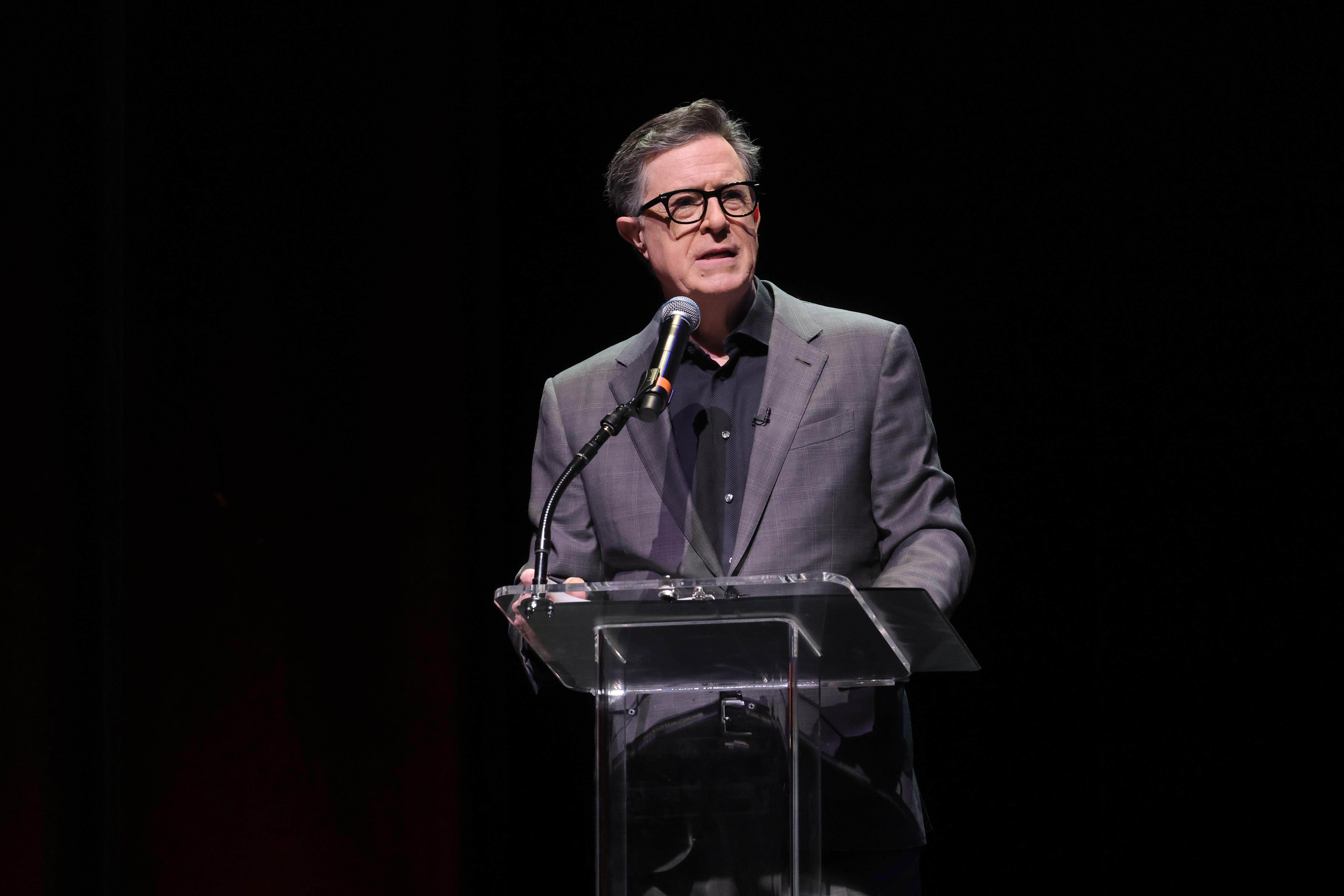 NEWARK, NEW JERSEY - DECEMBER 07: Stephen Colbert greets the audience before a conversation with Conan O'Brien to benefit Montclair Film at New Jersey Performing Arts Center on December 07, 2025 in Newark, New Jersey. (Photo by Michael Loccisano/Getty Images)