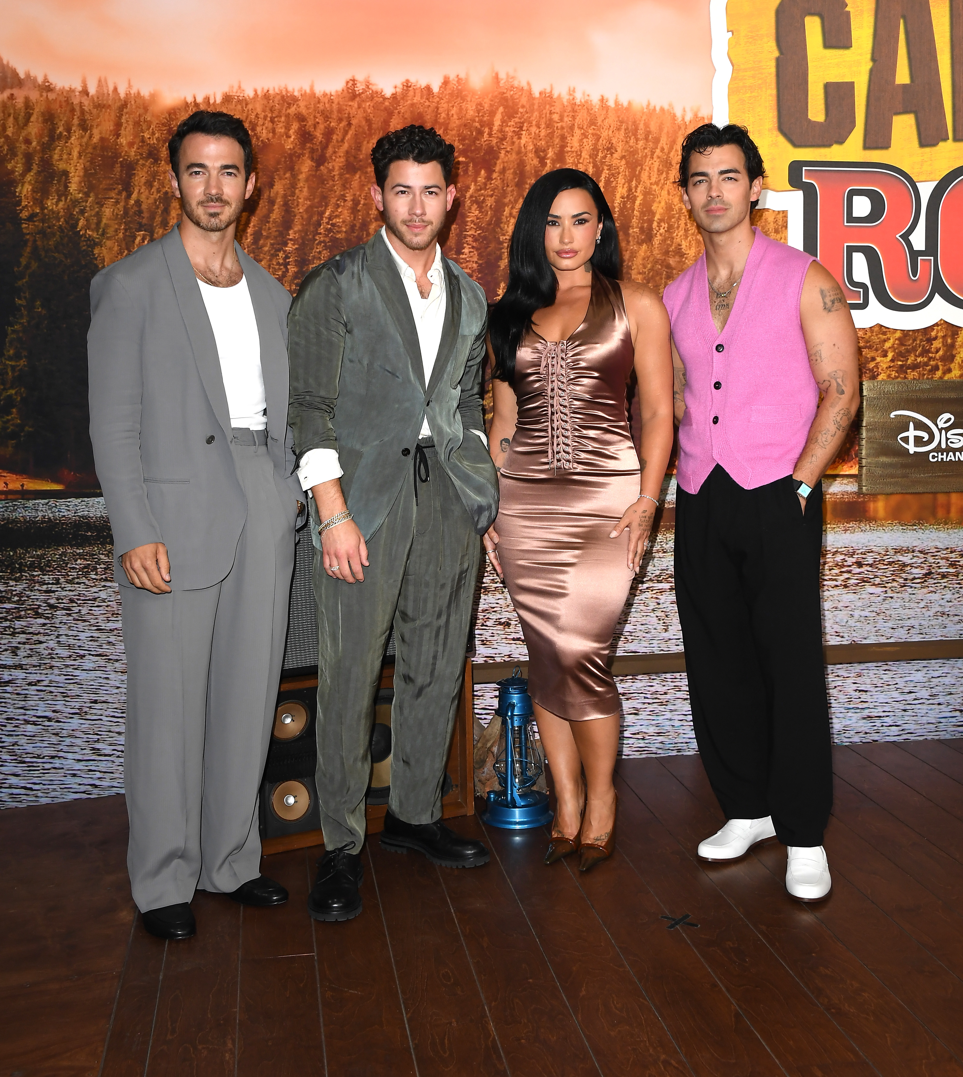 BURBANK, CALIFORNIA - AUGUST 10: Kevin Jonas, Nick Jonas, Demi Lovato, Joe Jonas arrives at the Los Angeles Premiere Of Disney's