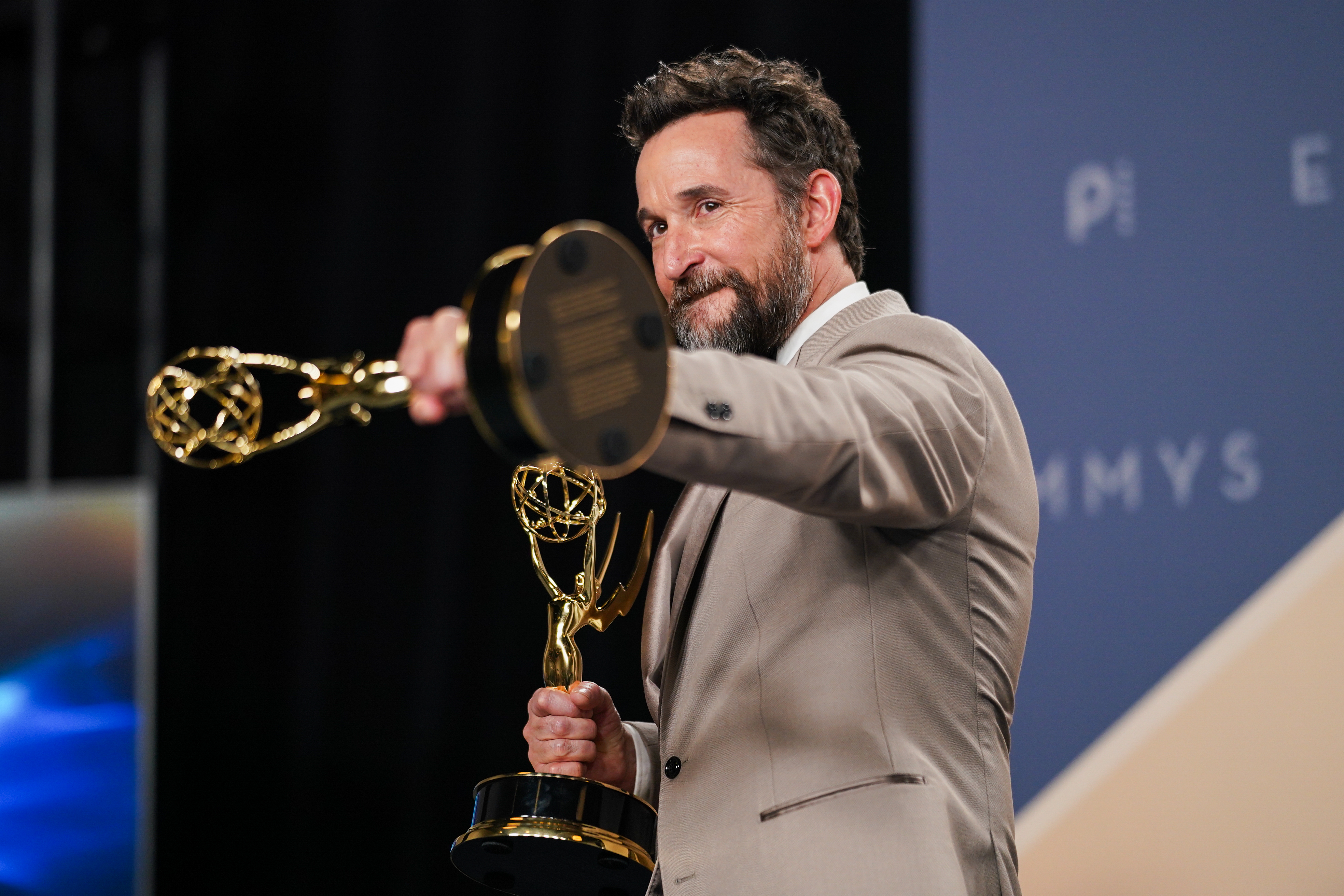 Noah Wyle poses in the press room with the awards for outstanding lead actor in a drama series for