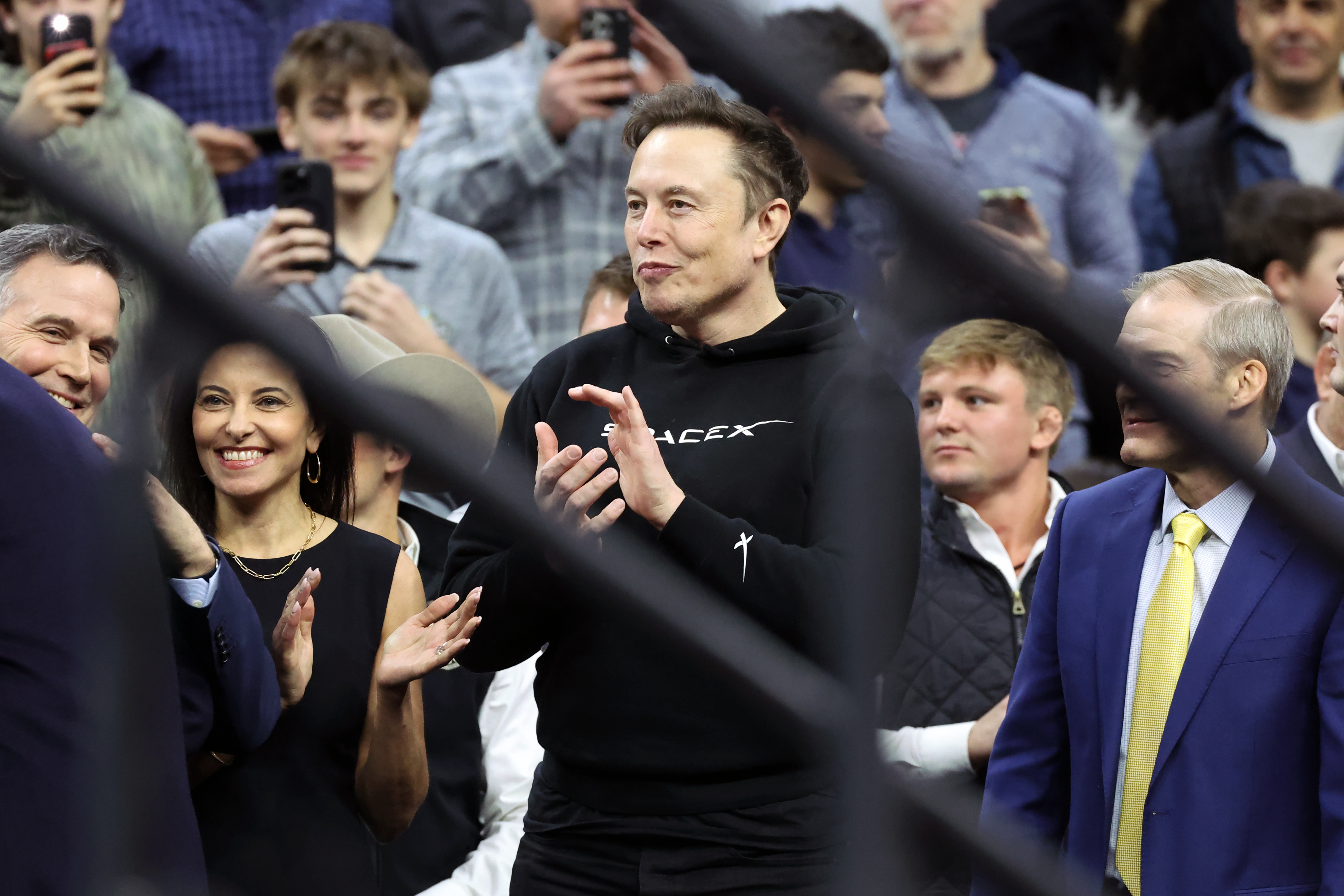 PHILADELPHIA, PENNSYLVANIA - MARCH 22: Elon Musk applauds during the 2025 NCAA Division I Wrestling Championships at the Wells Fargo Center on March 22, 2025 in Philadelphia, Pennsylvania. (Photo by Hunter Martin/Getty Images)