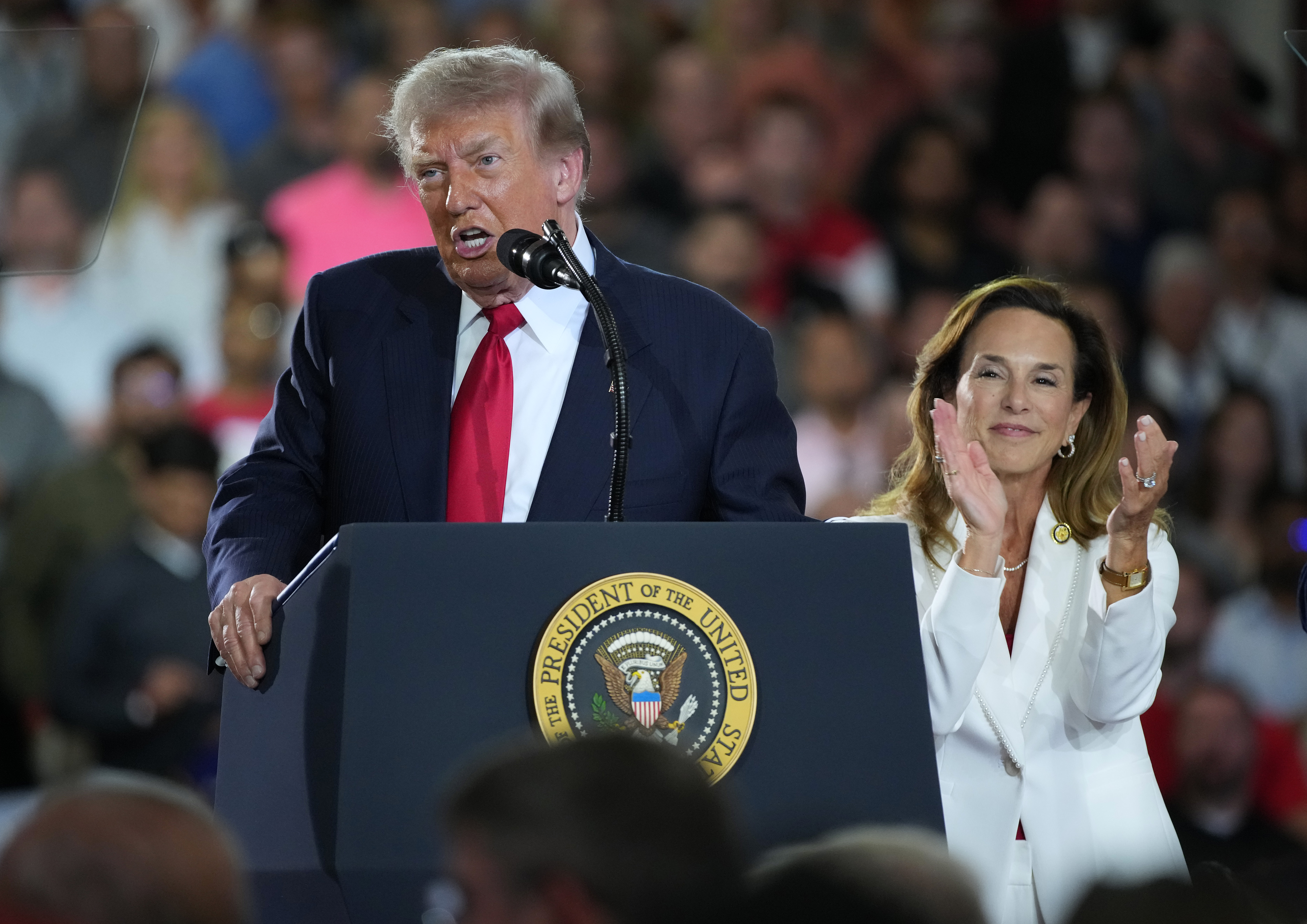 MILFORD, MICHIGAN - JULY 27: U.S. President Donald Trump speaks as Rep. Lisa McClain (R-MI) claps at General Motors’ Milford Proving Grounds on July 27, 2026 in Milford, Michigan. Trump is expected to address US auto manufacturing, tariffs and show support for Republican candidates ahead of the August 4 primary during the visit. (Photo by Andrew Harnik/Getty Images)