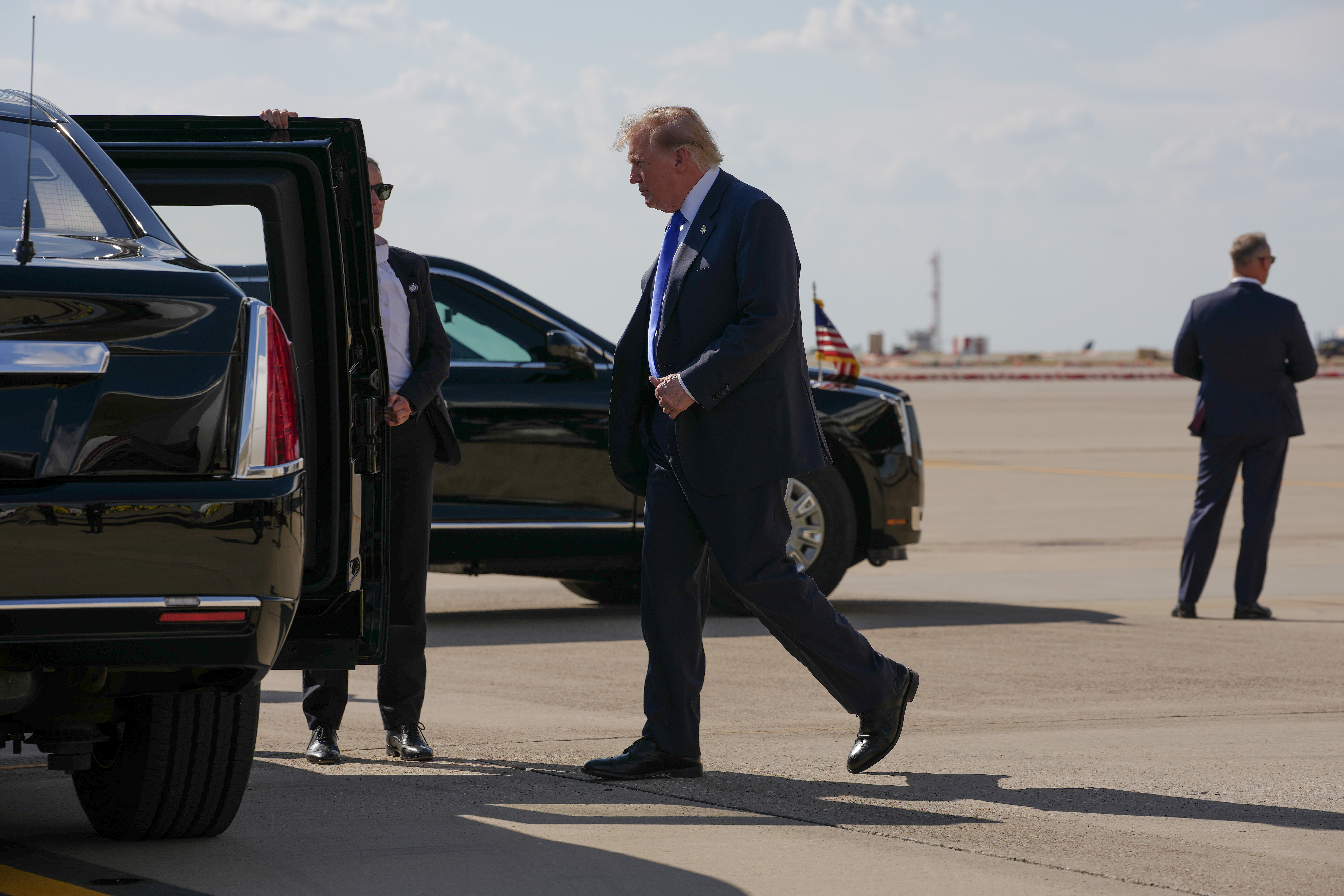 President Donald Trump walks to the presidential limousine, nicknamed