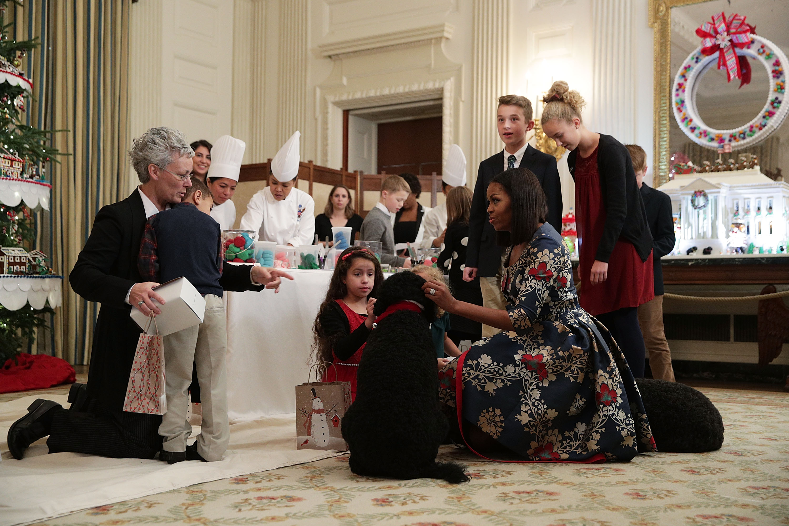 WASHINGTON, DC - NOVEMBER 29: U.S. first lady Michelle Obama introduces first dog Sunny to a little boy as she hosts military families to the White House to view the 2016 holiday decorations November 29, 2016 in Washington, DC. 'The Gift of the Holidays' is the theme of this year's White House holiday decorations. (Photo by Alex Wong/Getty Images)