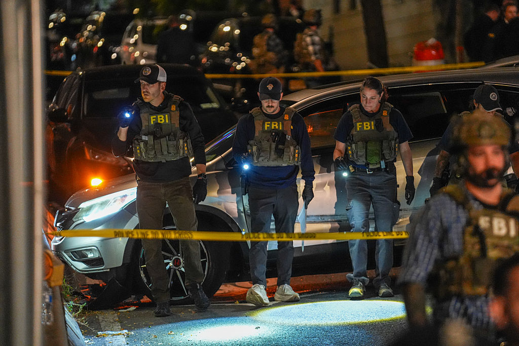 NEW YORK, NEW YORK - OCTOBER 8: Federal Bureau of Investigation (FBI) agents work  at the scene where a man was allegedly shot by an Immigration and Customs Enforcement (ICE) officer during an operation in the Bronx borough of New York is seen on October 8, 2026, in New York City. According to local media and the NYPD, the driver was shot, conscious, and transported to a local hospital. (Photo by Ryan Murphy/Getty Images)