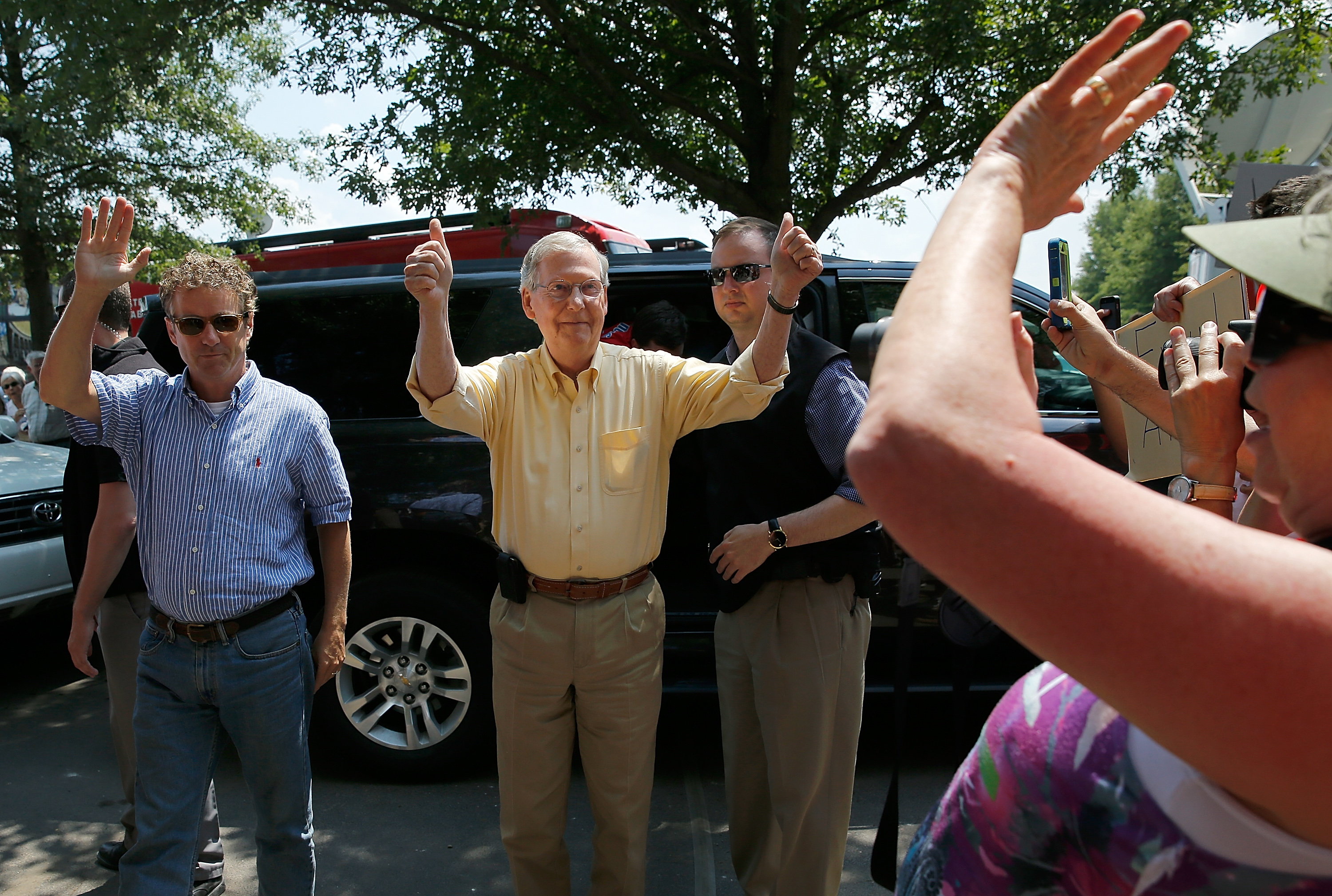 FANCY FARM, KY - AUGUST 02: Senate Minority Leader Mitch McConnell (2L) (R-KY) and Sen. Rand Paul (L) (R-KY) wave to supporters as they arrive at the Fancy Farm picnic August 2, 2014 in Fancy Farm, Kentucky. With today's annual Fancy Farm picnic, a Kentucky political tradition, recent polls show McConnell and the Democratic nominee, Kentucky Secretary of State Alison Grimes in a virtual tie. (Photo by Win McNamee/Getty Images)