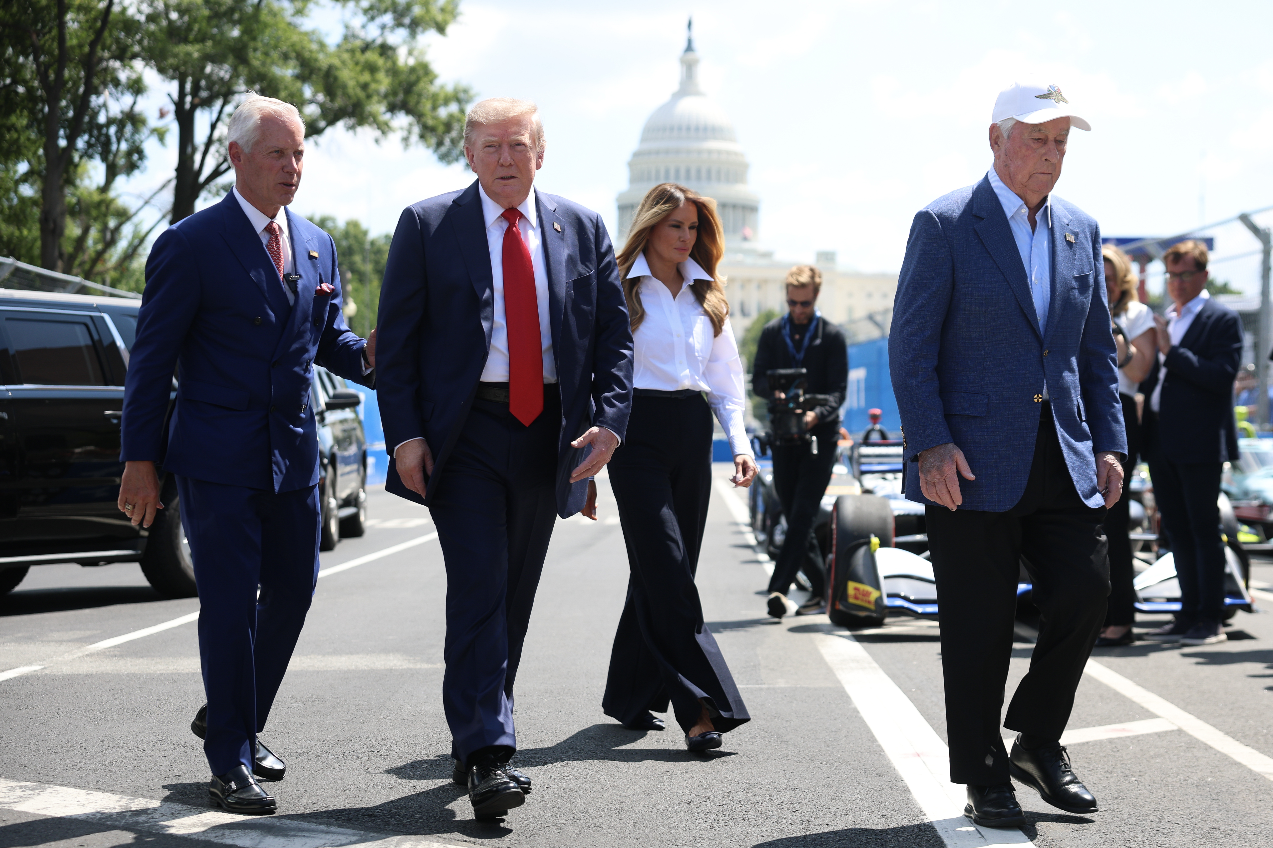 WASHINGTON, DC - AUGUST 23: U.S. President Donald Trump and first lady Melania Trump greet drivers on the paddock of the NTT INDYCAR Series on August 23, 2026 in Washington, DC. U.S. President Donald Trump established the Freedom 250 Grand Prix weekend as part of the yearlong celebration of America's 250th anniversary. (Photo by Kevin Dietsch/Getty Images)