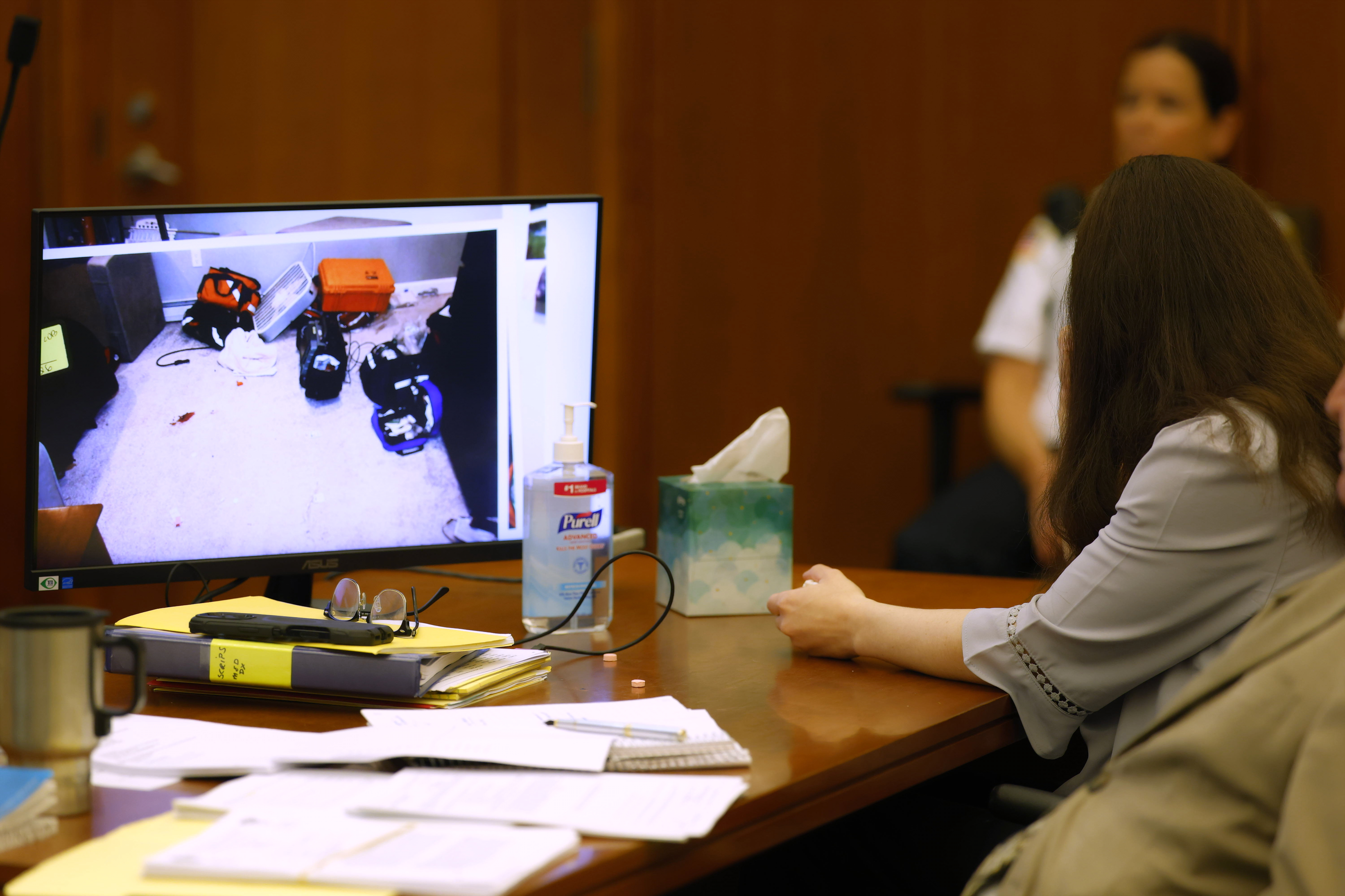 Defendant Lindsay Clancy looks away from a photograph on a display as she listens during her murder trial at Plymouth Superior Court in Plymouth, Mass., on Thursday, July 30, 2026. (CJ Gunther/The Boston Herald via AP, Pool)