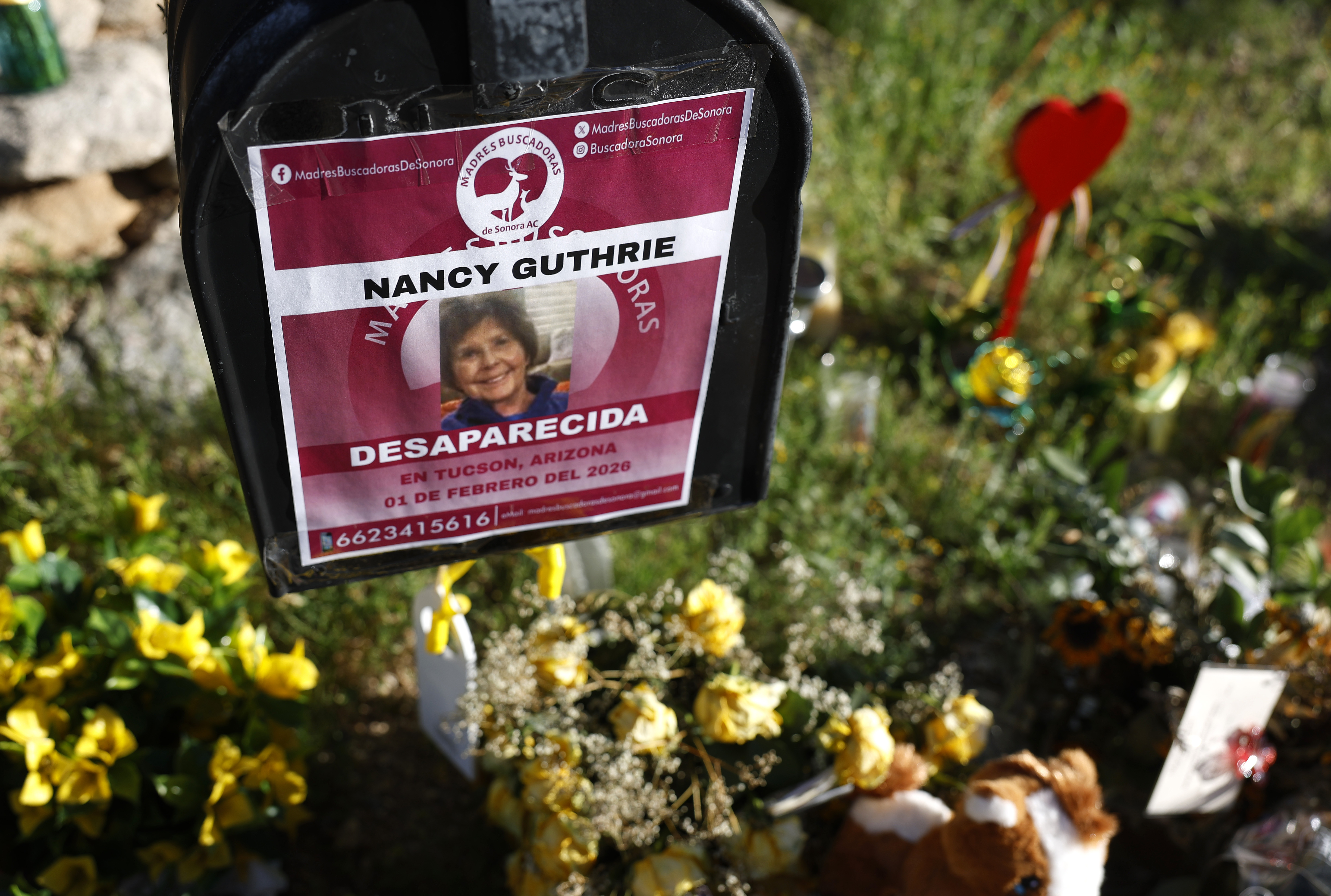 TUCSON, ARIZONA - FEBRUARY 27: Flowers and signs are seen in a makeshift memorial in front of the home of Nancy Guthrie on February 27, 2026 in Tucson, Arizona. Law enforcement officials continue to search for Nancy Guthrie, the 84-year-old mother of U.S. journalist and television host Savannah Guthrie, after she went missing from her home on the morning of February 1st. (Photo by Justin Sullivan/Getty Images)