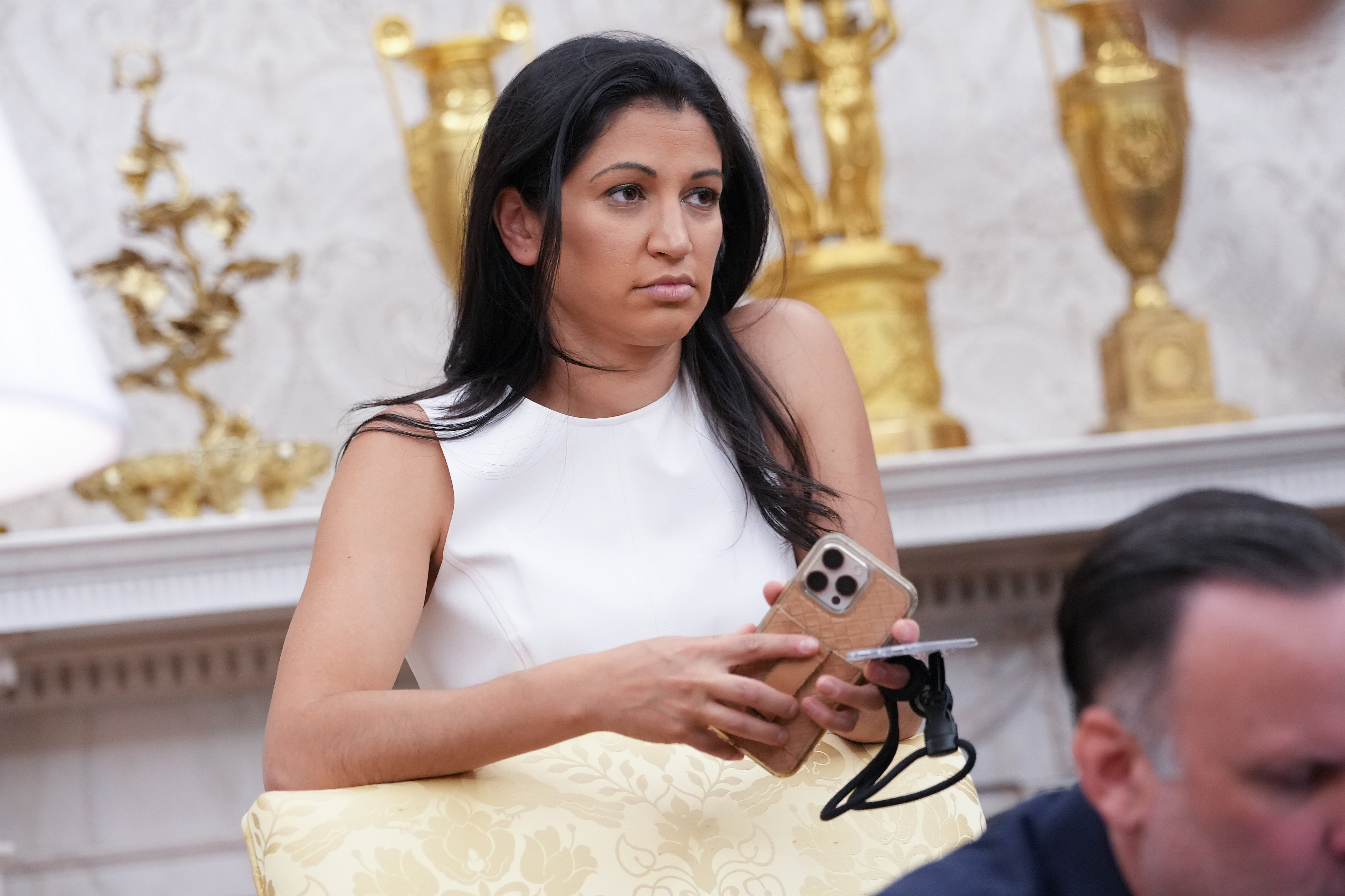 WASHINGTON, DC - MAY 30: White House Deputy Chief of Staff Stephen Miller's wife, Katie Miller, listens as U.S. President Donald Trump and Tesla CEO Elon Musk speak to reporters in the Oval Office of the White House on May 30, 2025 in Washington, DC. Musk, who served as an adviser to Trump and led the Department of Government Efficiency, announced he would leave his role in the Trump administration to refocus on his businesses.  (Photo by Kevin Dietsch/Getty Images)