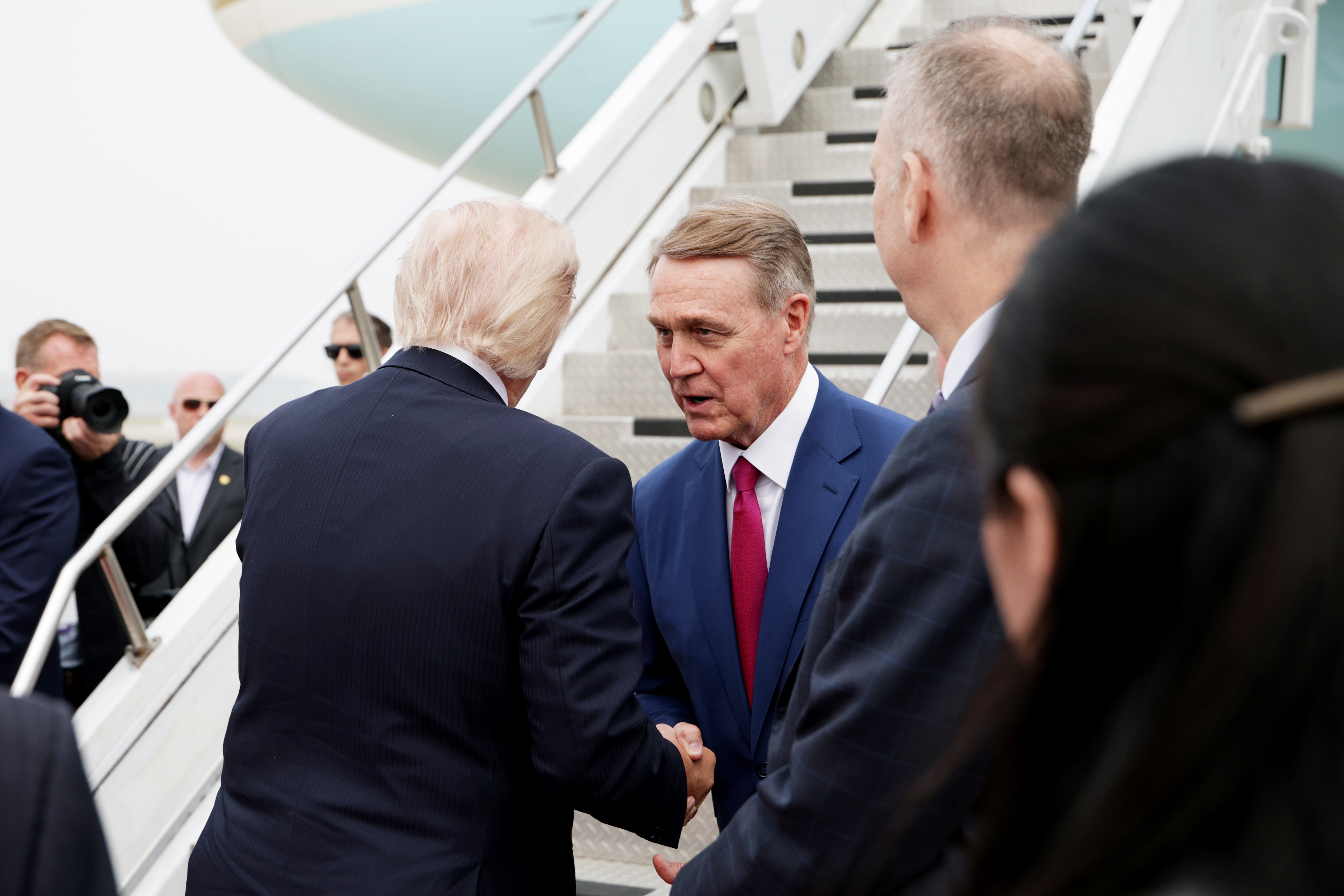 President Donald Trump shakes hands with Ambassador to China David Perdue as he prepares to board Air Force One at Beijing Capital International Airport on May 15, 2026 in Beijing, China (Photo by Alex Wong/Getty Images)