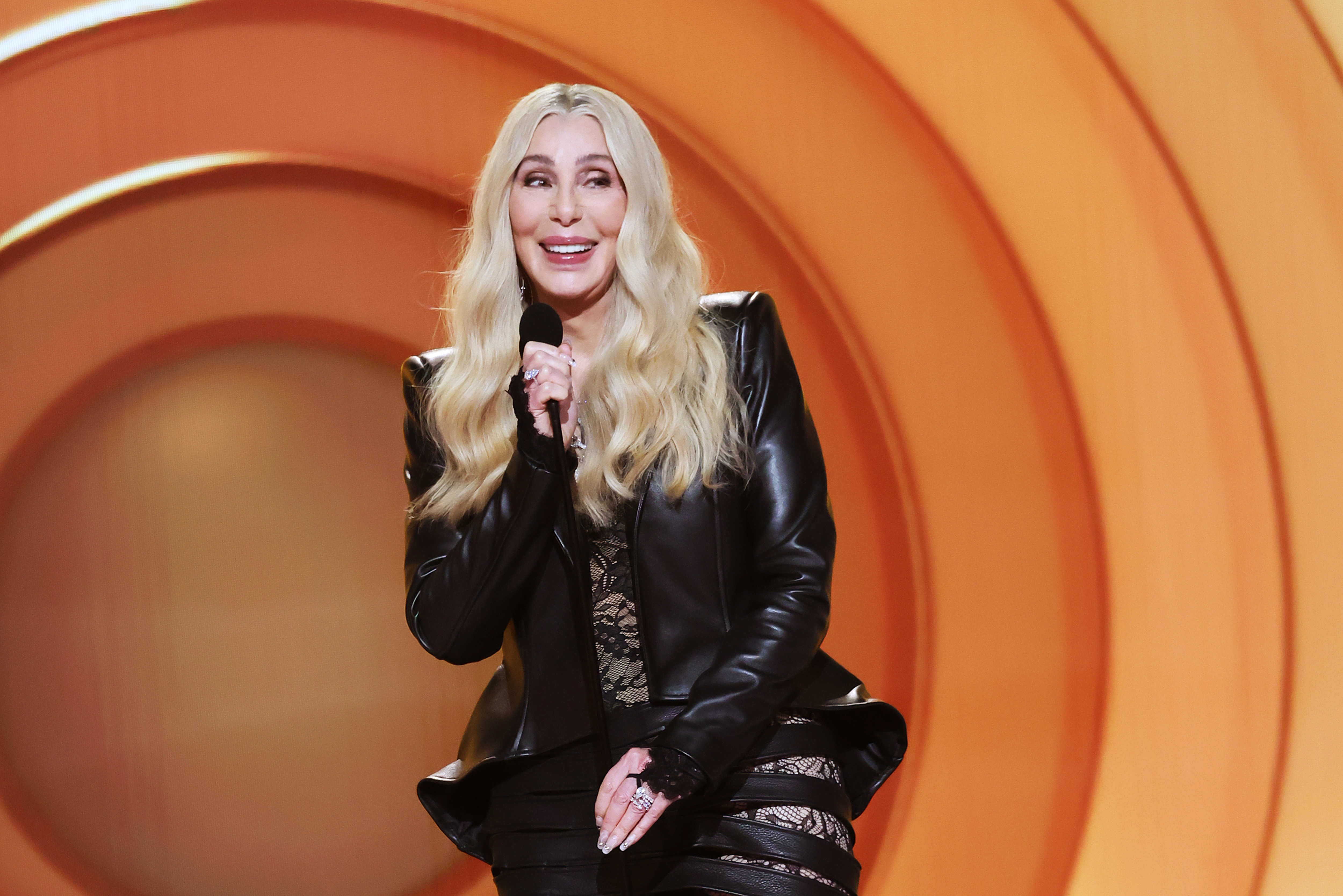 LOS ANGELES, CALIFORNIA - FEBRUARY 01: Cher speaks onstage during the 68th GRAMMY Awards at Crypto.com Arena on February 01, 2026 in Los Angeles, California.  (Photo by Johnny Nunez/Getty Images for The Recording Academy)