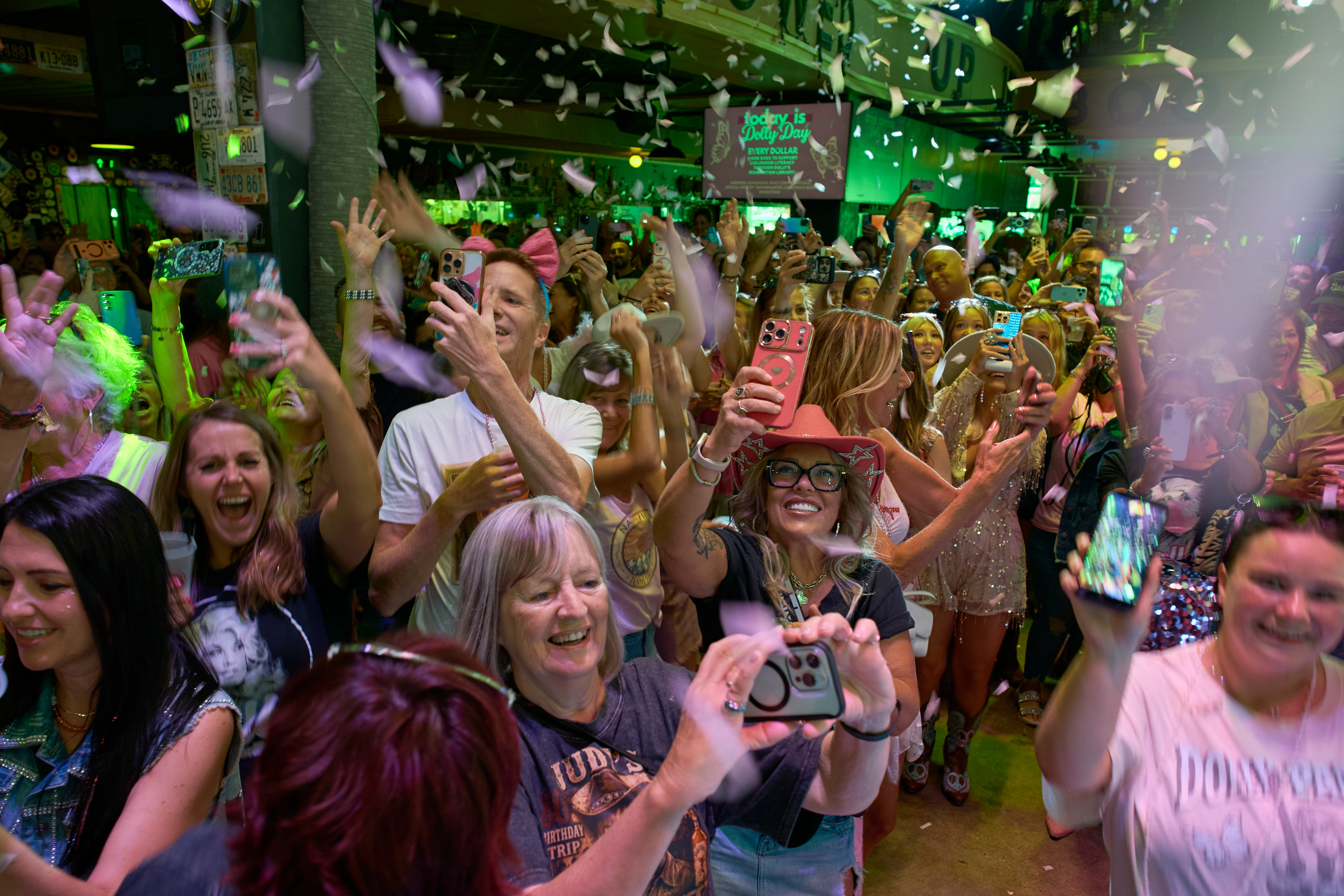 People celebrate at a bar on Broadway as the song