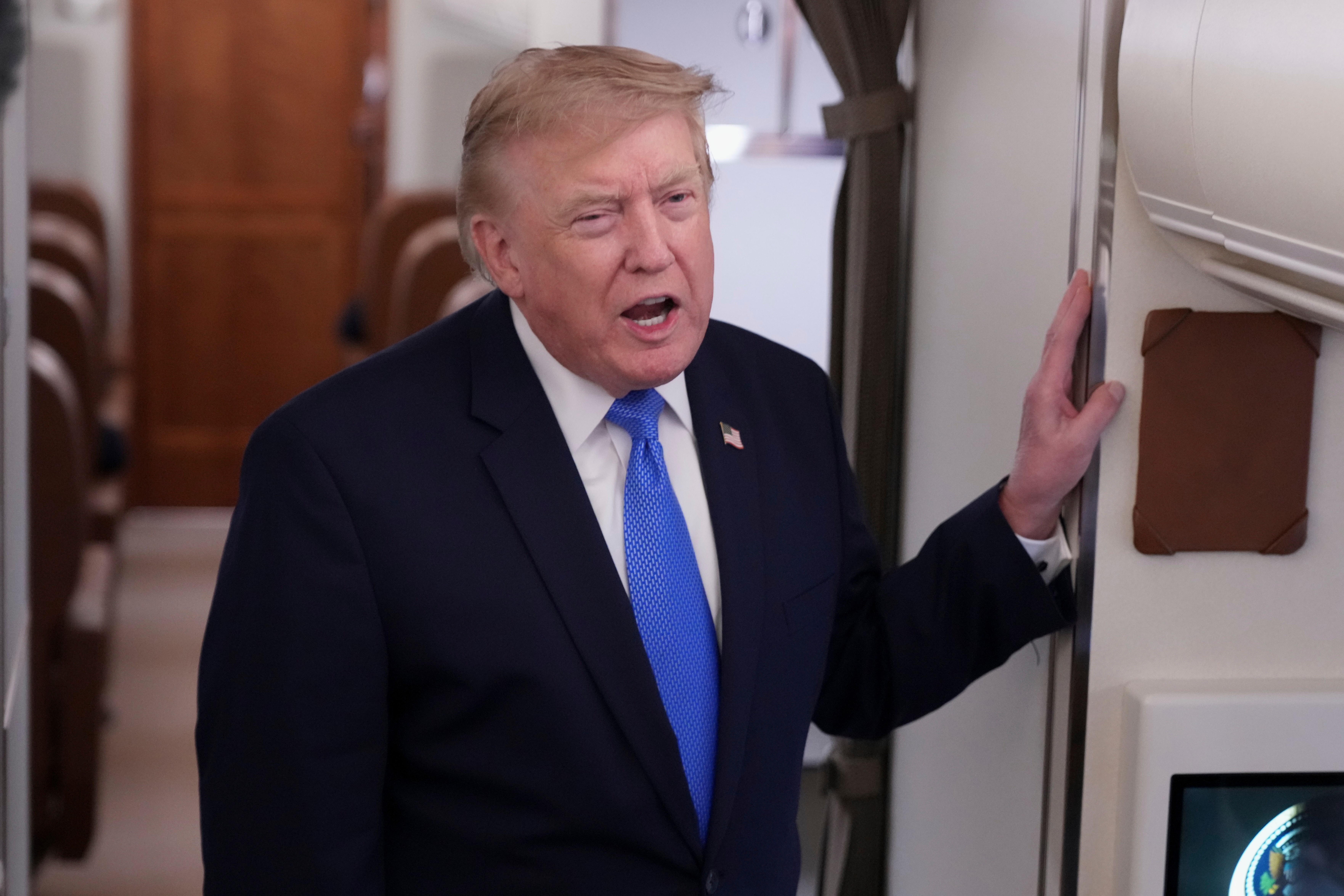 President Donald Trump speaks to reporters onboard Air Force One while returning to the White House, Sunday, Aug. 2, 2026. (AP Photo/Jacquelyn Martin)