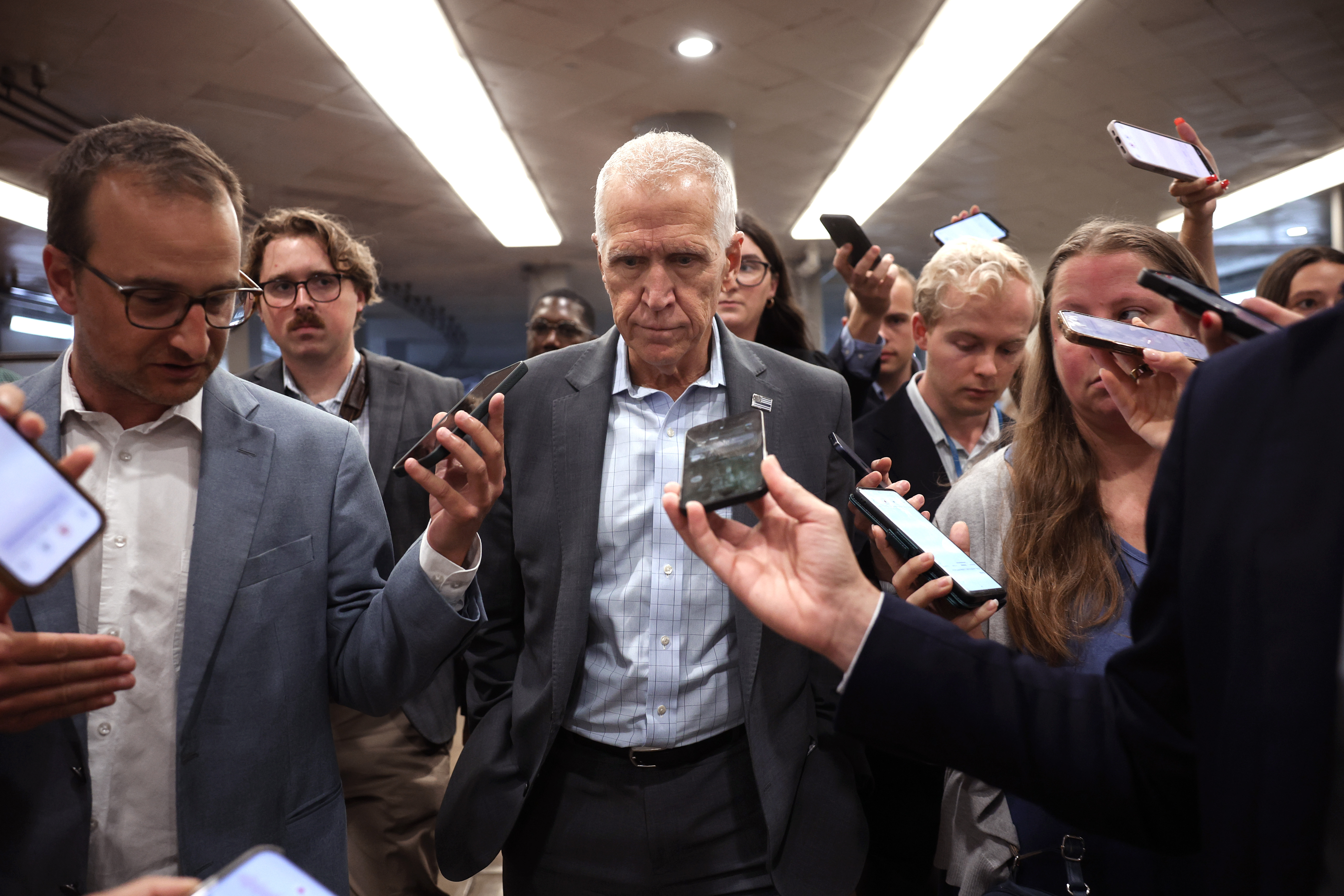 WASHINGTON, DC - JULY 30: U.S. Sen. Thom Tillis (R-NC) speaks to reporters as he walks though a hallway at the U.S. Capitol on July 30, 2026 in Washington, DC. Tillis and Sen. John Cornyn (R-TX) are withholding support for President Donald Trump's nominee for U.S. attorney general, Todd Blanche, until they get reassurances on Trump’s IRS lawsuit settlement and the elimination of the “anti-weaponization fund