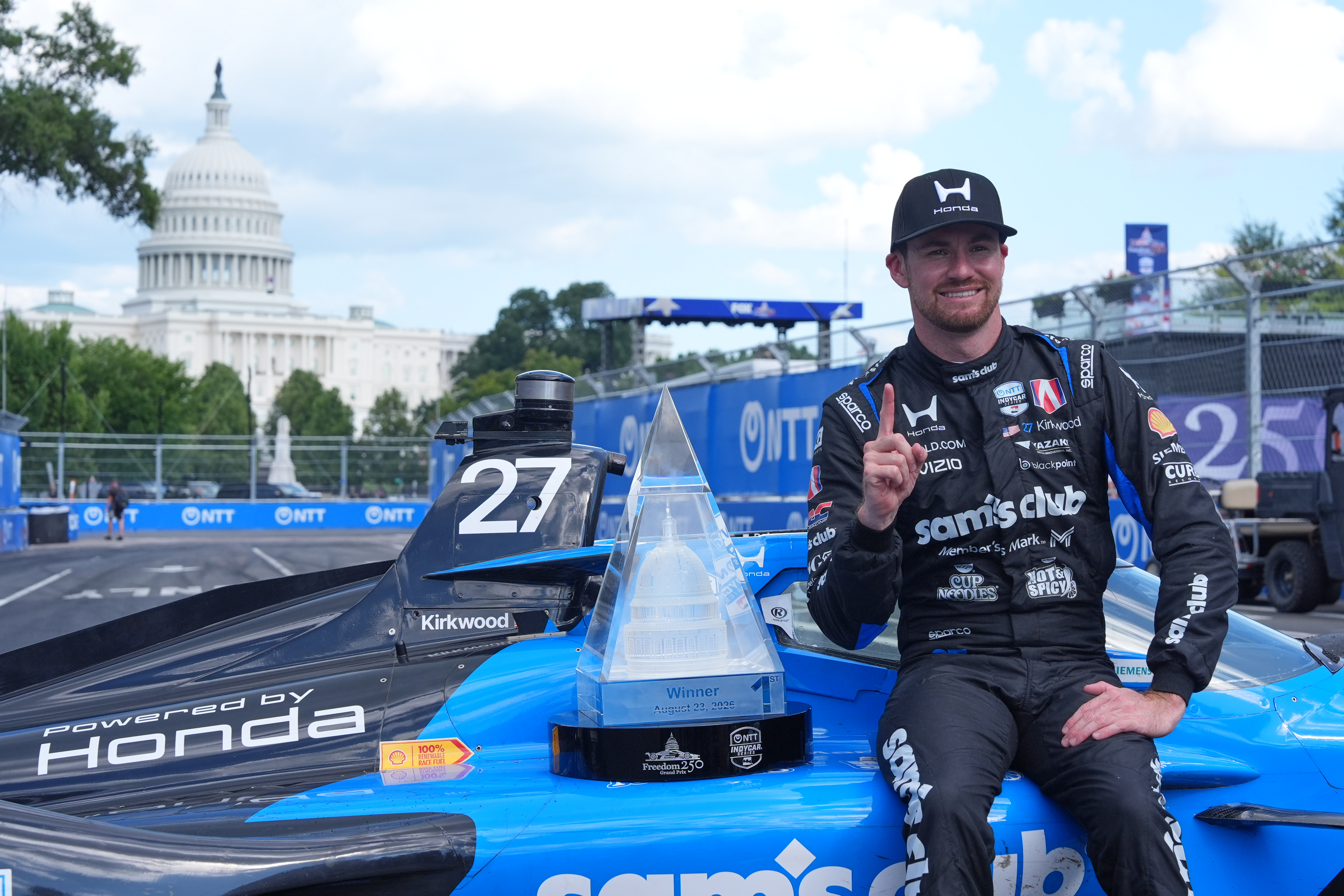 Kyle Kirkwood (27) poses for a photo after winning the IndyCar Freedom 250 Grand Prix auto race in Washington, Sunday, Aug. 23, 2026. (AP Photo/Alex Brandon)