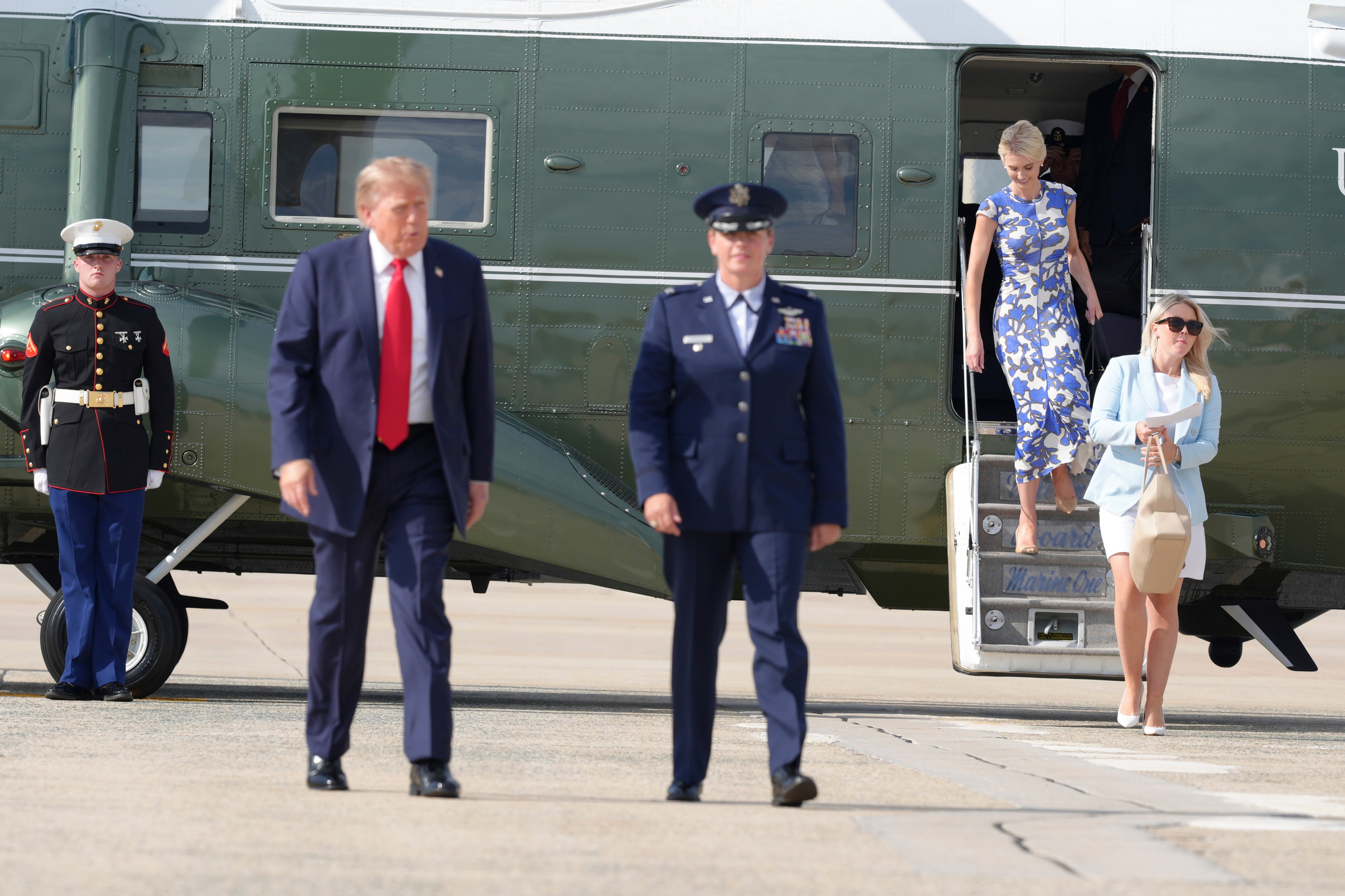 White House press secretary Karoline Leavitt, from right, and White House aide Natalie Harp arrive with President Donald Trump, second left, on Marine One, Friday, Aug. 21, 2026, at Joint Base Andrews, Md., en route to South Carolina. (AP Photo/Jacquelyn Martin)