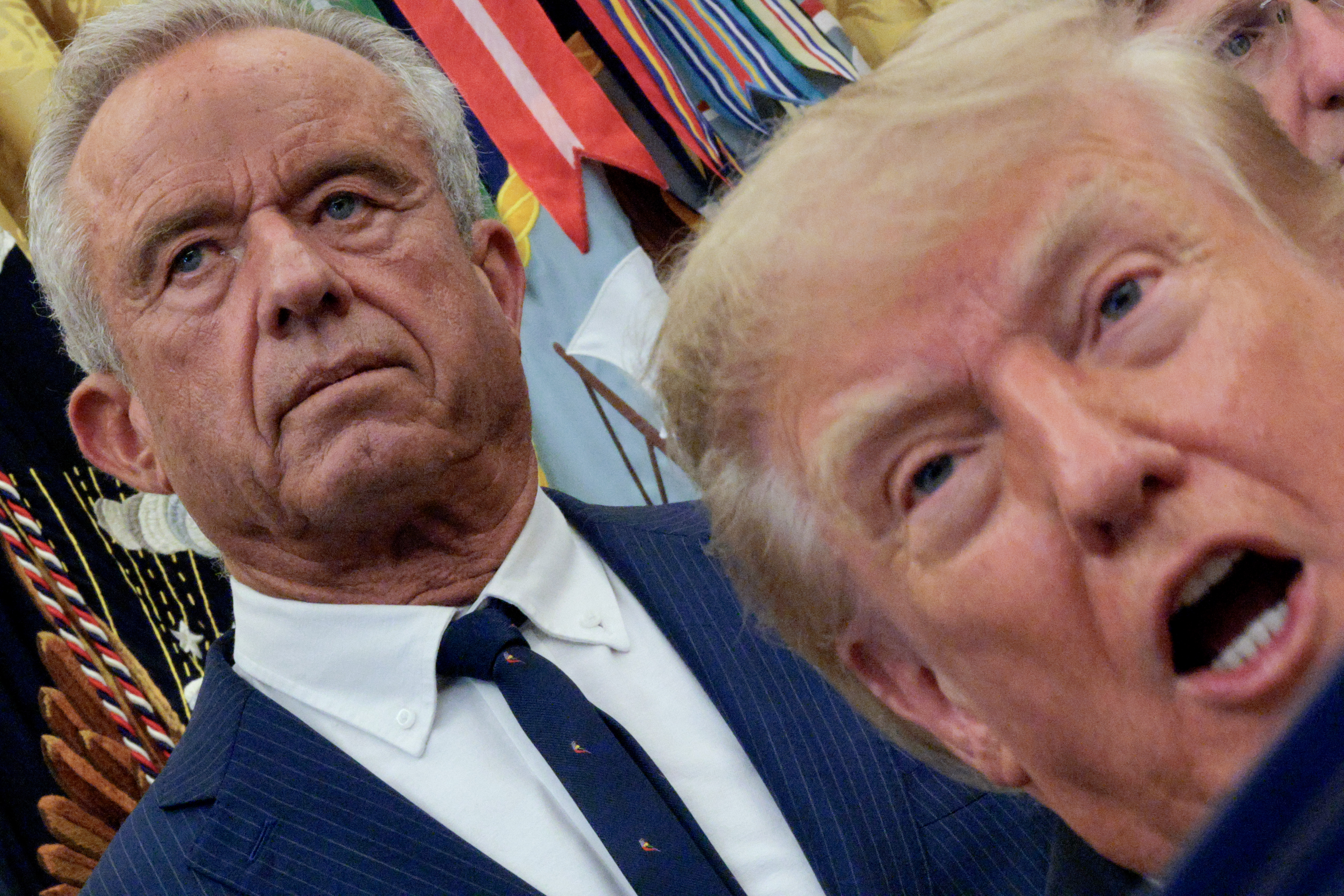 WASHINGTON, DC - SEPTEMBER 18: U.S. Secretary of Health and Human Services Robert F. Kennedy Jr. listens as U.S. President Donald Trump speaks to the media about healthcare in the Oval Office at the White House on September 18, 2026 in Washington, DC. Trump announced that his administration's Medicaid ​