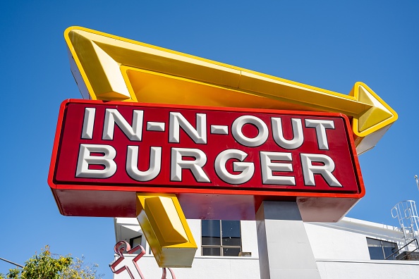 In-N-Out Burger sign with red and yellow logo against clear blue sky outside a building, San Francisco, California, April 17, 2026. (Photo by Smith Collection/Gado/Getty Images)