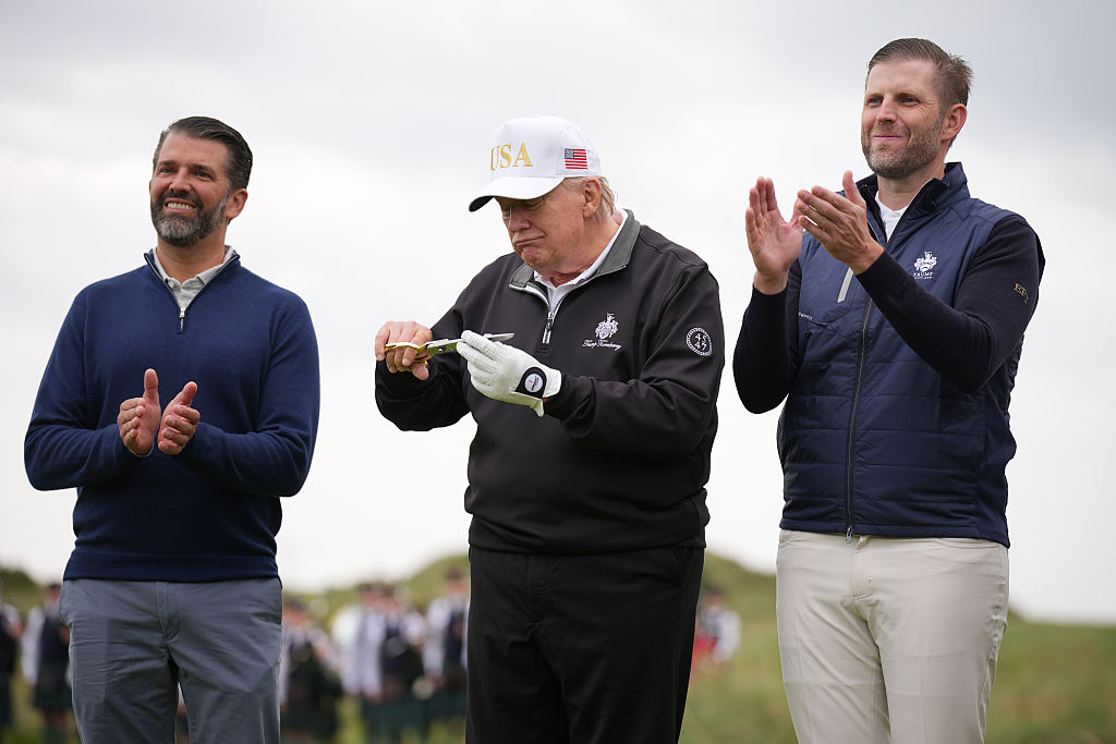 U.S. President Donald Trump gestures next to Donald Trump Jr. (L) and Eric Trump as they attend the ribbon-cutting ceremony at a new 18-hole course at Trump International Golf Links on July 29, 2025 in Balmedie, near Aberdeen, Scotland.