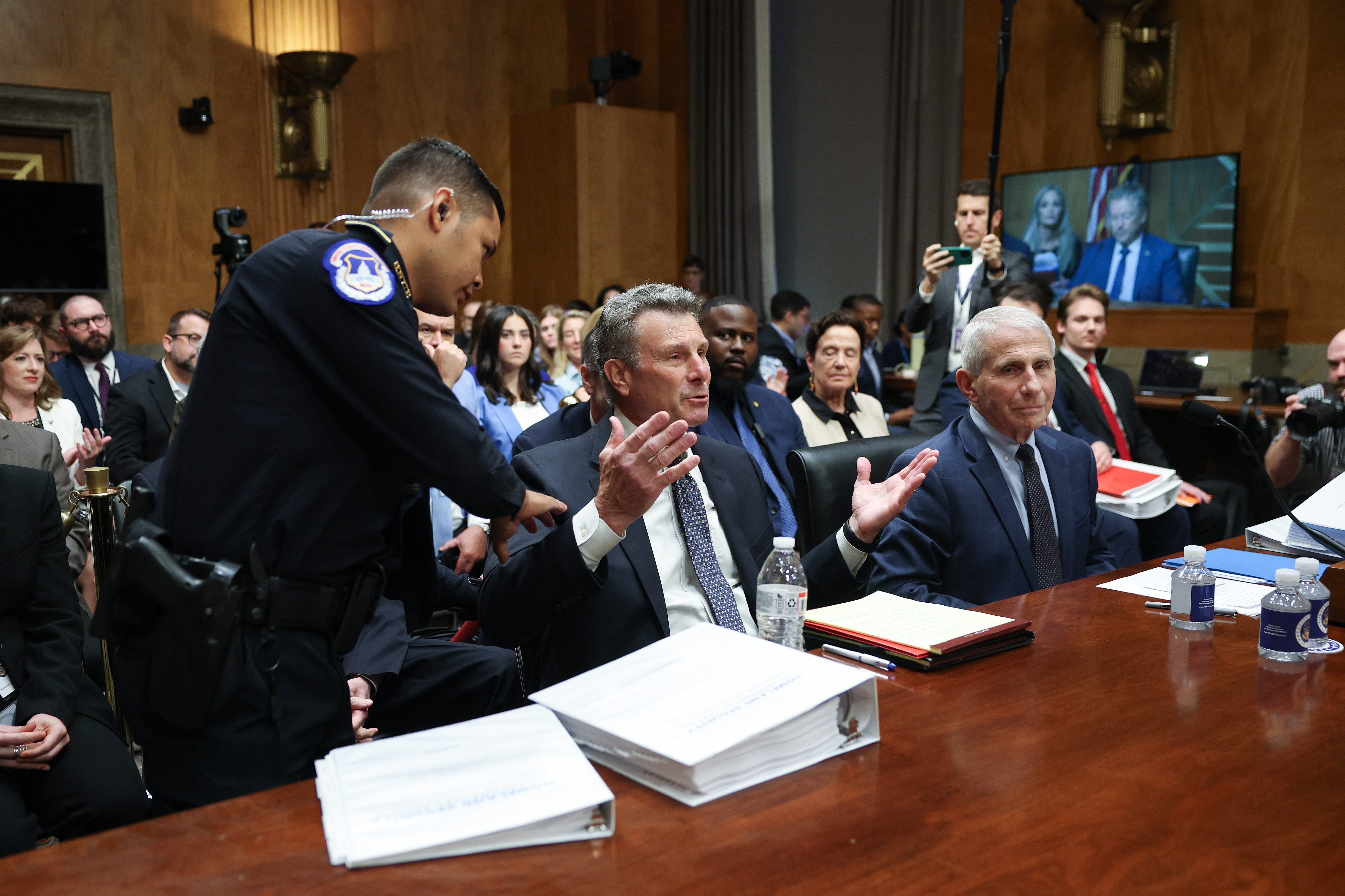 WASHINGTON, DC - JULY 29:  David Schertler (C), the attorney for former NIH Director Anthony Fauci (R), is removed from the hearing room at the direction of committee chairman Sen. Rand Paul (R-KY) during a hearing before the Senate Homeland Security and Governmental Affairs Committee July 29, 2026 in Washington, DC.  Fauci declined to answer questions from the committee asserting his fifth amendment right during the hearing.   (Photo by Kevin Dietsch/Getty Images)