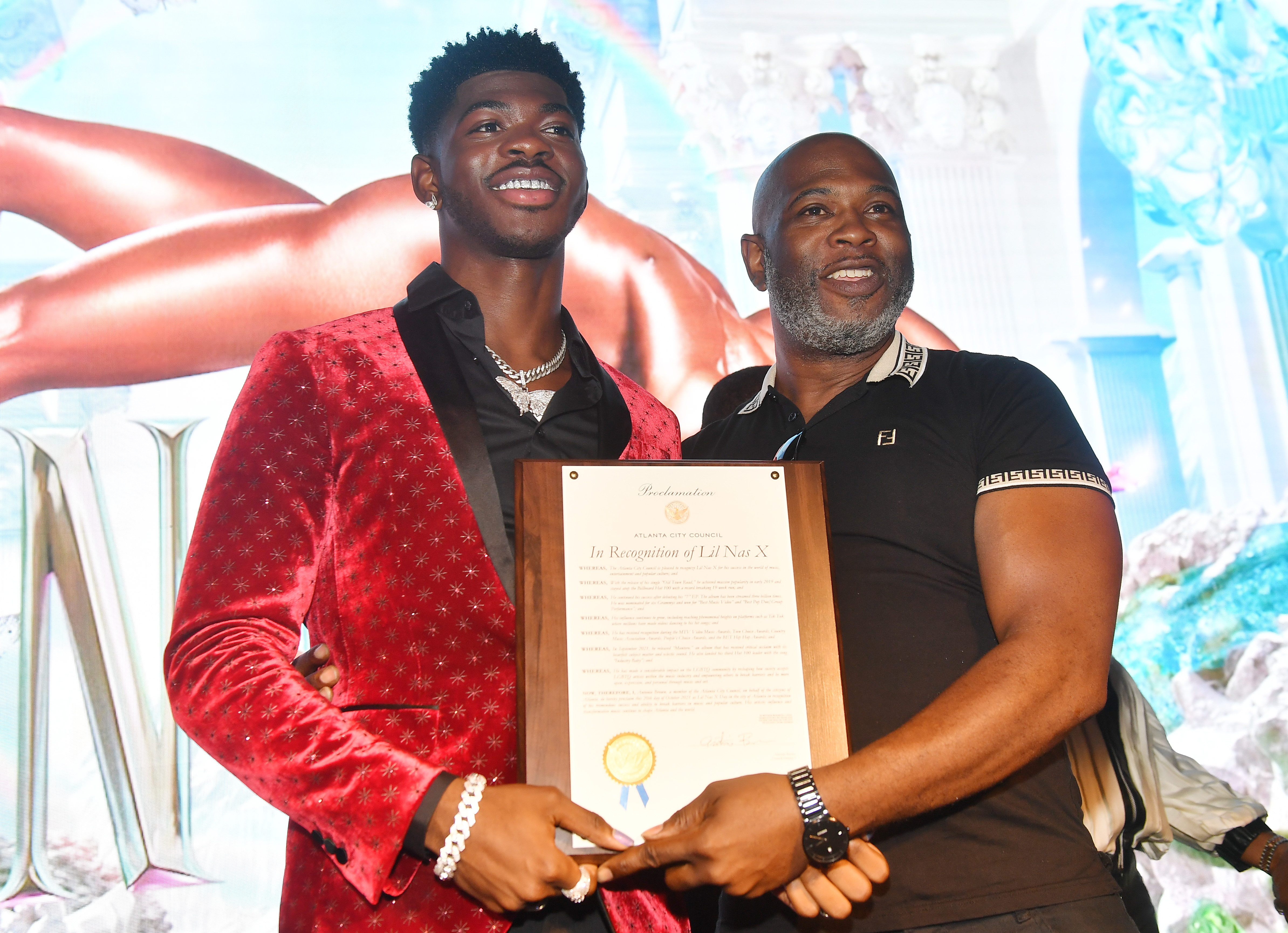 ATLANTA, GEORGIA - OCTOBER 20:  Lil Nas X poses with his father Robert Stafford onstage during the Lil Nas X Homecoming Event at The Gathering Spot on October 20, 2021 in Atlanta, Georgia. (Photo by Paras Griffin/Getty Images)