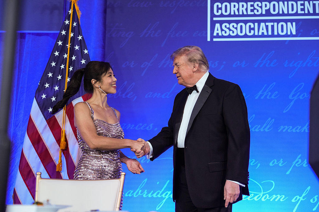 U.S. President Donald Trump greets White House Correspondents Association President Weijia Jiang during the re-scheduled White House Correspondents Dinner in the Presidential Ballroom at the Waldorf...