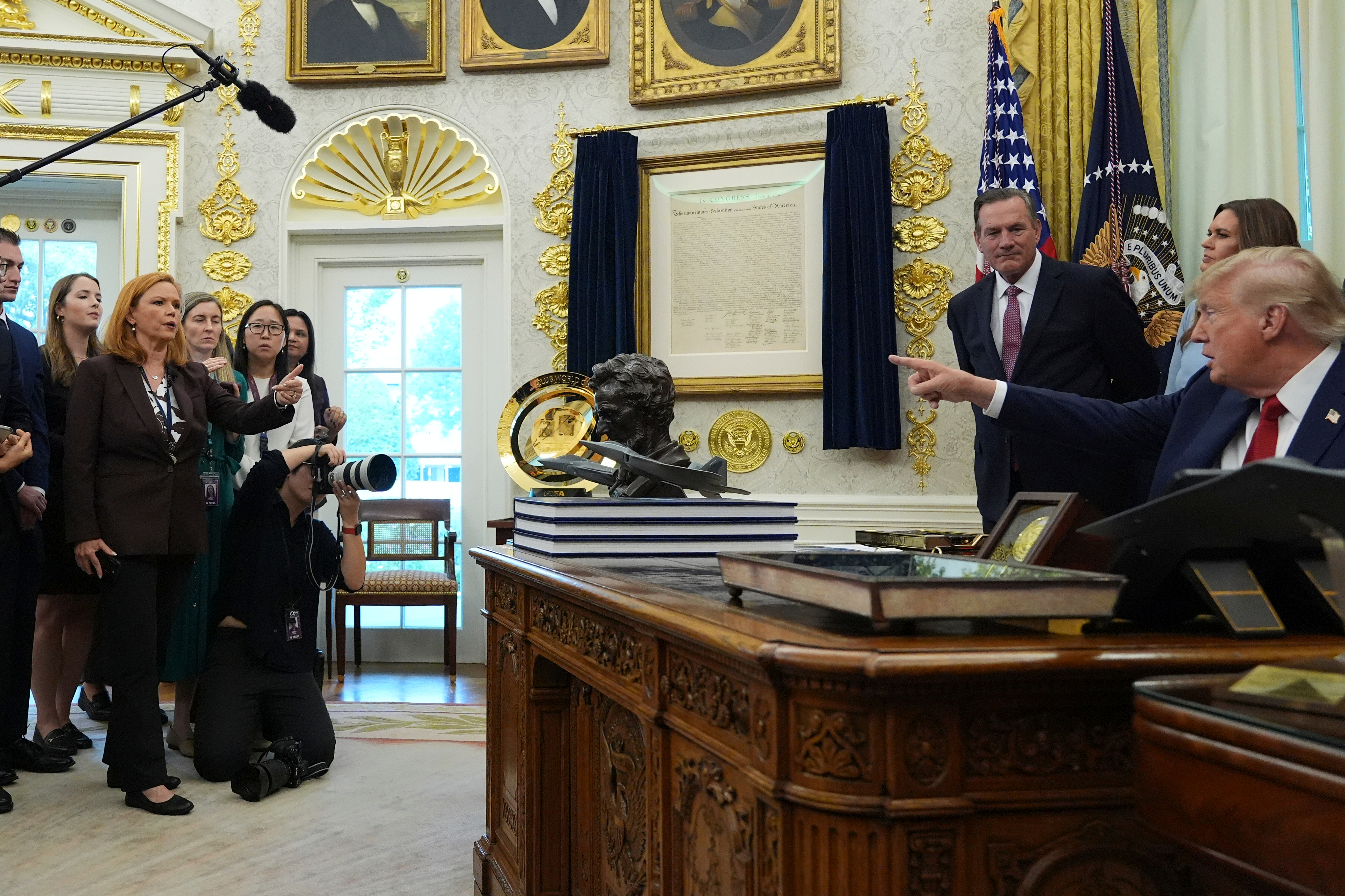 Kelly O'Donnell, of NBC News, left, gestures as he asks a question as President Donald Trump points to reporters as he speaks during an event about healthcare in the Oval Office of the White House, Friday Sept. 18, 2026, in Washington. (AP Photo/Jacquelyn Martin)