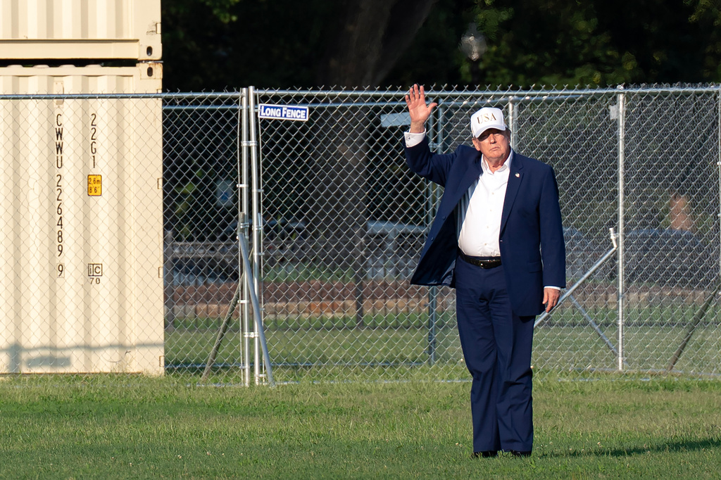 President Donald Trump waves to the media as he walks from Marine One to his limousine, upon his arrival at the Ellipse just outside of the White House, Sunday, Aug. 9, 2026, in Washington. (AP Photo/Jose Luis Magana)