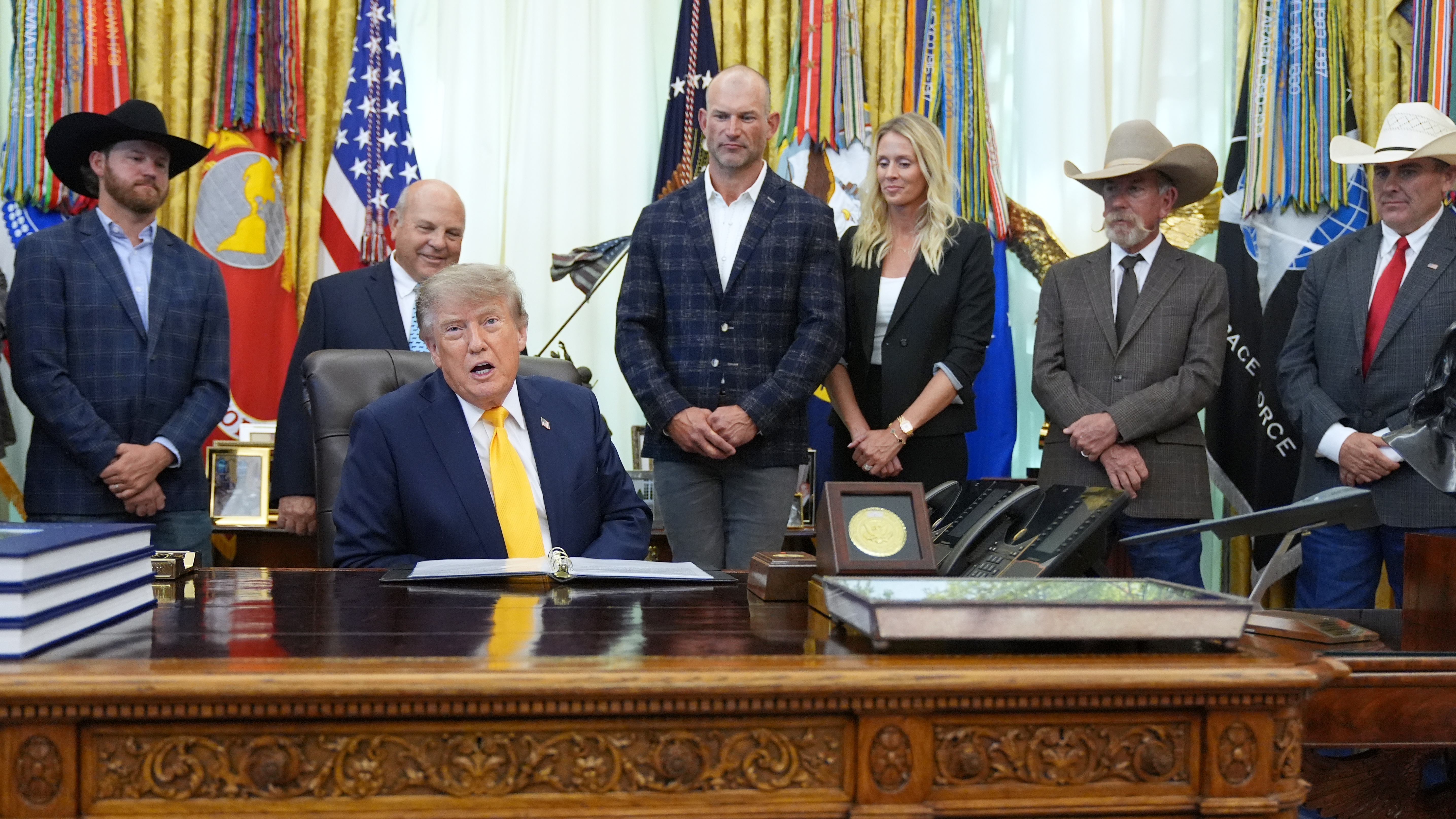 President Donald Trump speaks and announces action to help farmers and ranchers with meat processing, as a group of farmers and ranchers stand behind, Friday, Sept. 4, 2026, in the Oval Office of the White House, in Washington. (AP Photo/Jacquelyn Martin)