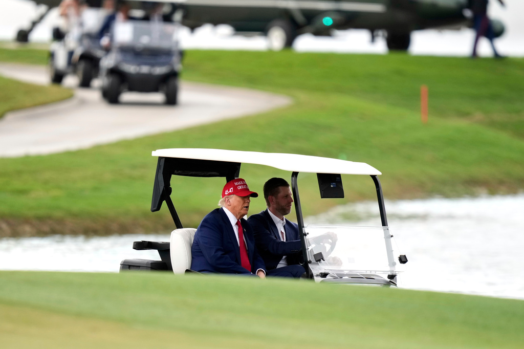 FILE - President Donald Trump, driven by his son Eric Trump, arrives at Trump National Doral during the LIV Golf Miami tournament, April 3, 2025, in Miami. (AP Photo/Alex Brandon, File)