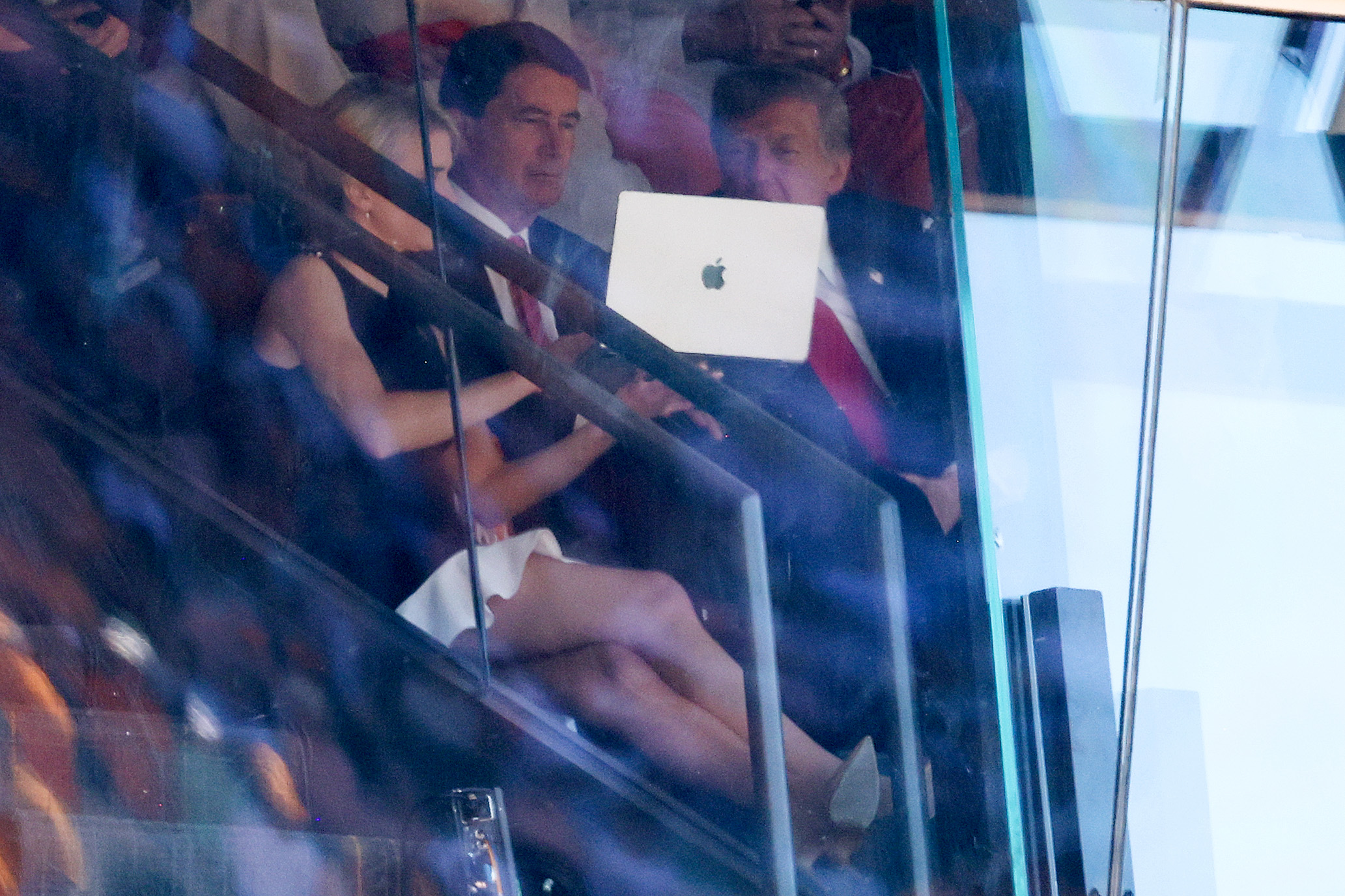 KNOXVILLE, TENNESSEE - SEPTEMBER 26: U.S. President Donald Trump and Sen. Bill Hagerty (R-TN) are shown a laptop computer by Trump's personal assistant Natalie Harp during the Texas-Tennessee football game at Neyland Stadium on September 26, 2026 in Knoxville, Tennessee. Trump, who has attended more college football games than any recent sitting president, attended the game between the No. 1 Longhorns and the No. 14. Volunteers, one of the biggest matchups in the country this weekend. (Photo by Tom Brenner/Getty Images)