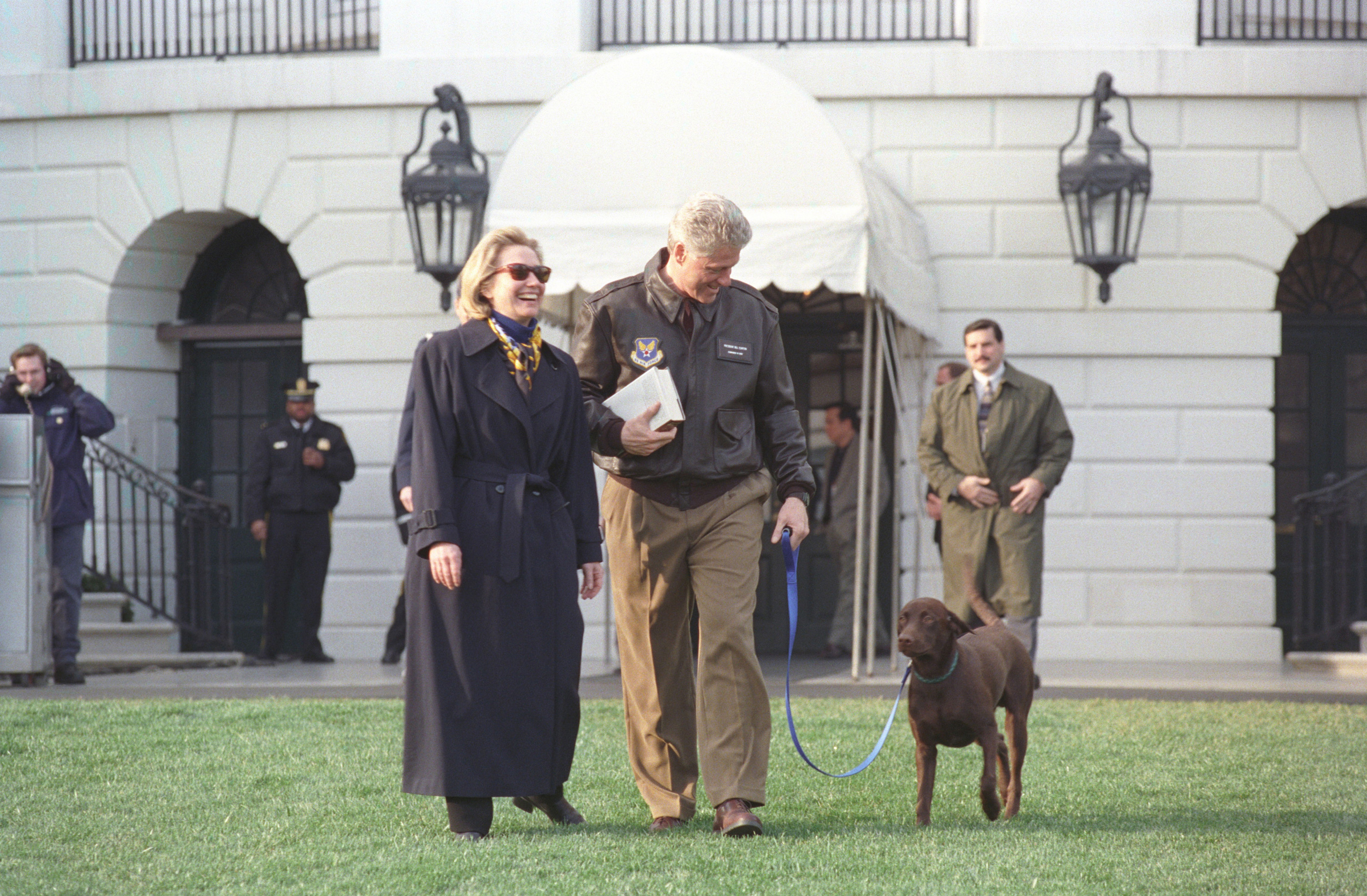 President William Jefferson Clinton and First Lady Hillary Rodham Clinton with Buddy the Dog en route to Marine One, March 3, 1998. Image courtesy National Archives. (Photo via Smith Collection/Gado/Getty Images).